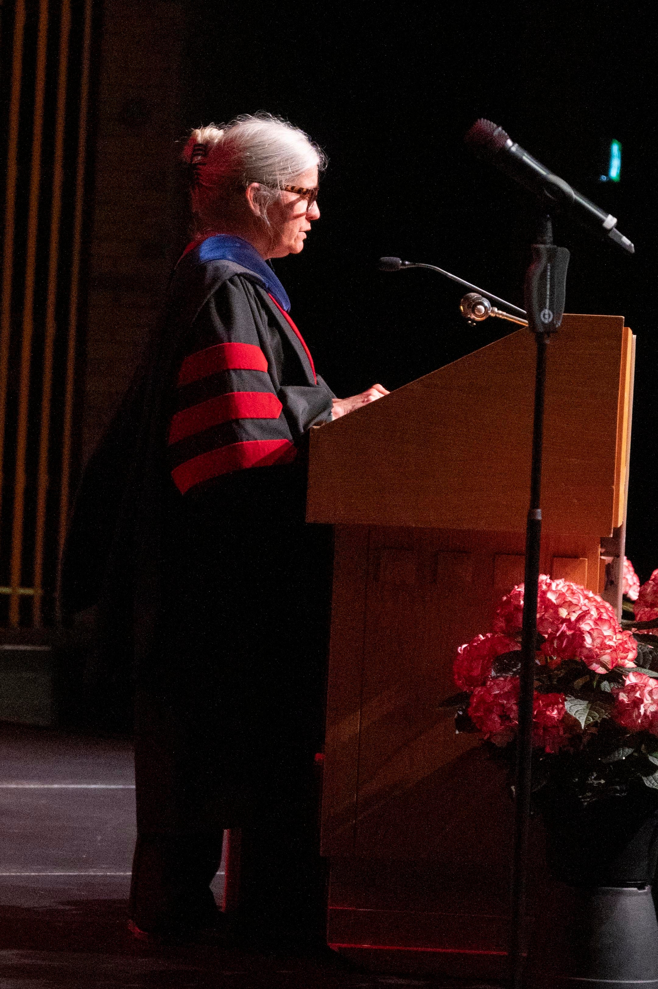 Laura Gray giving the convocation address at a podium