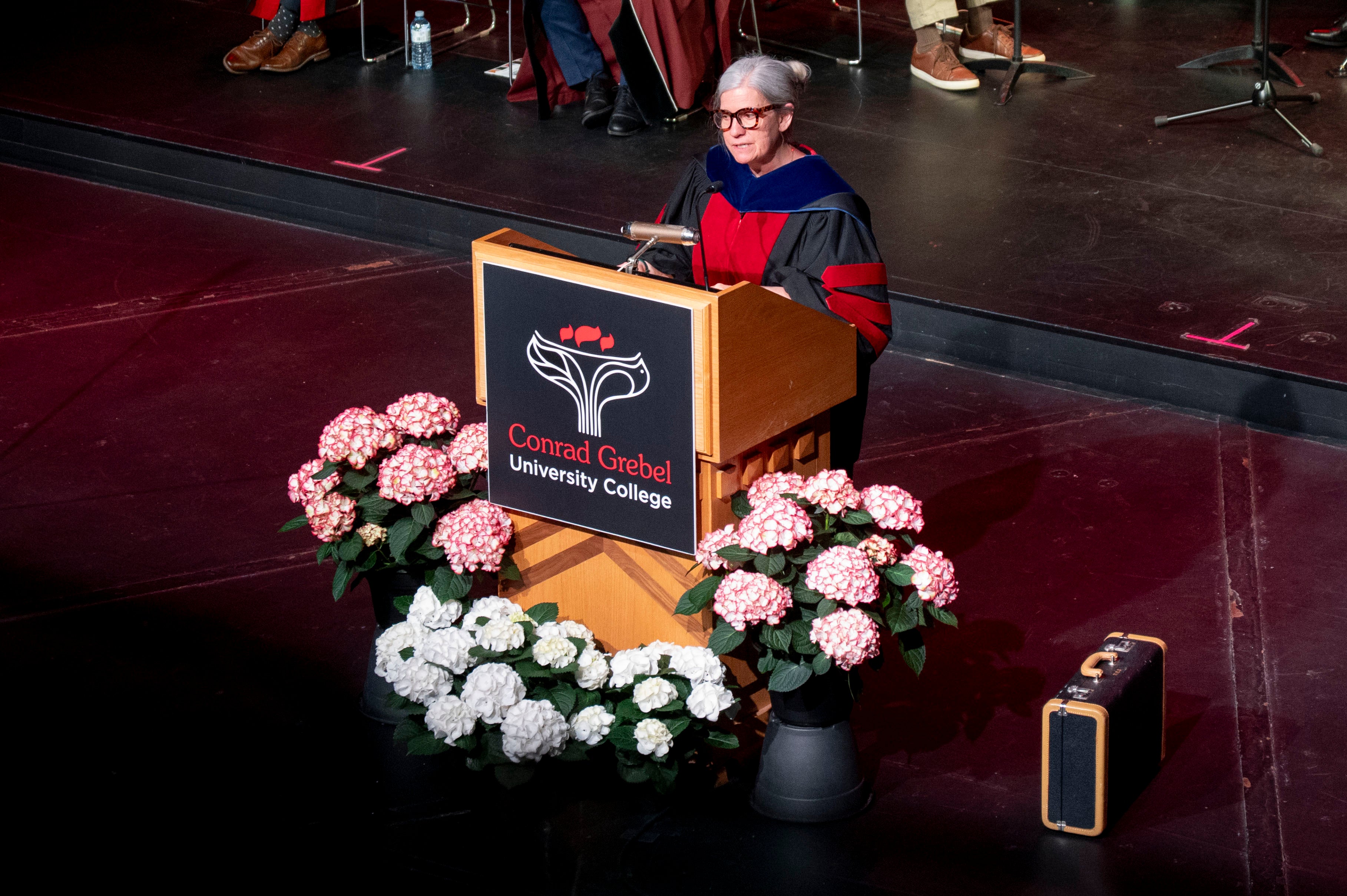 Laura Gray giving the convocation address at a podium