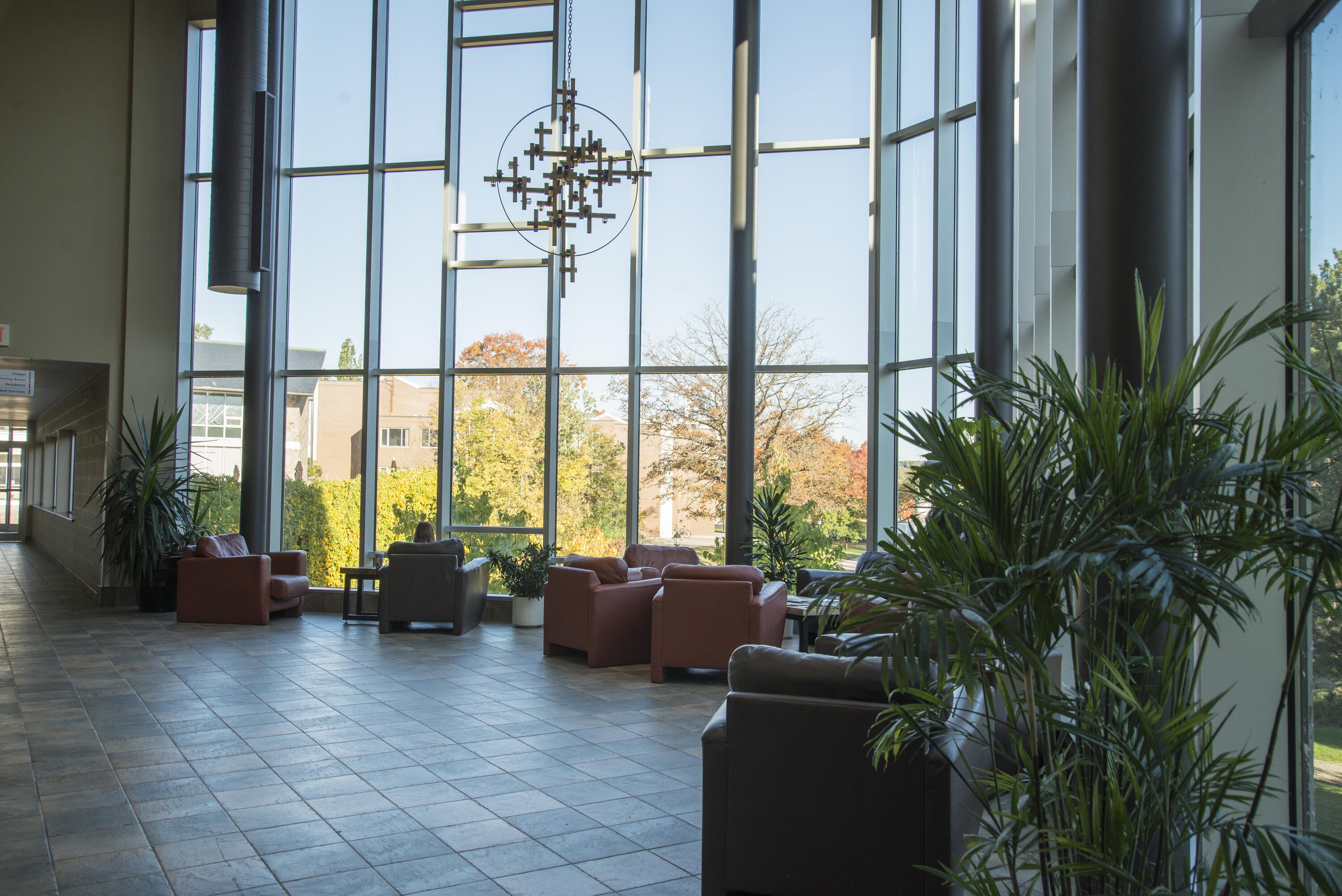 Large atrium with floor to ceiling windows and comfortable chairs