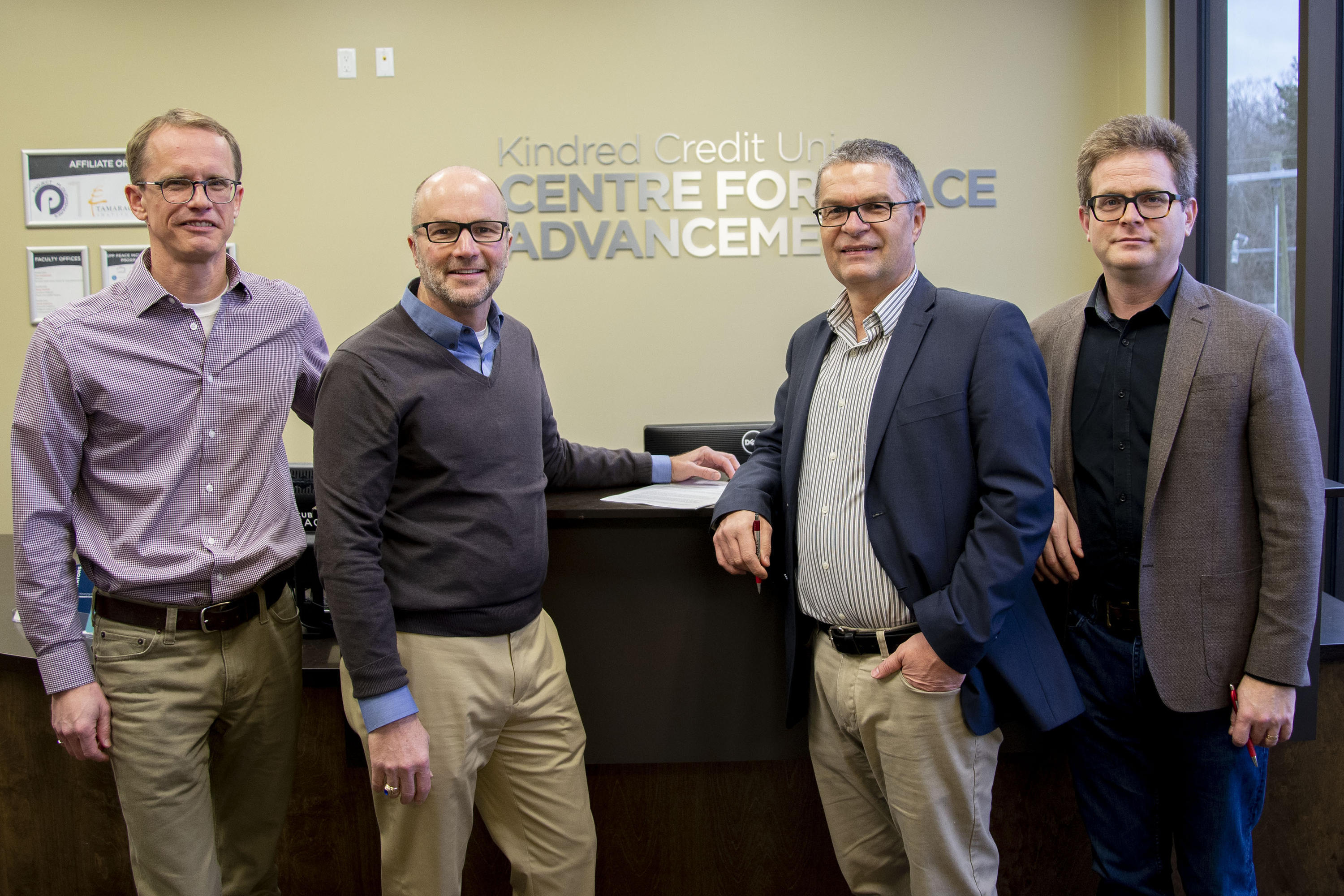 Paul Heidebrecht, John Head, Rick Cober Bauman, and Marcus Shantz pose with signed Memorandum of Understanding