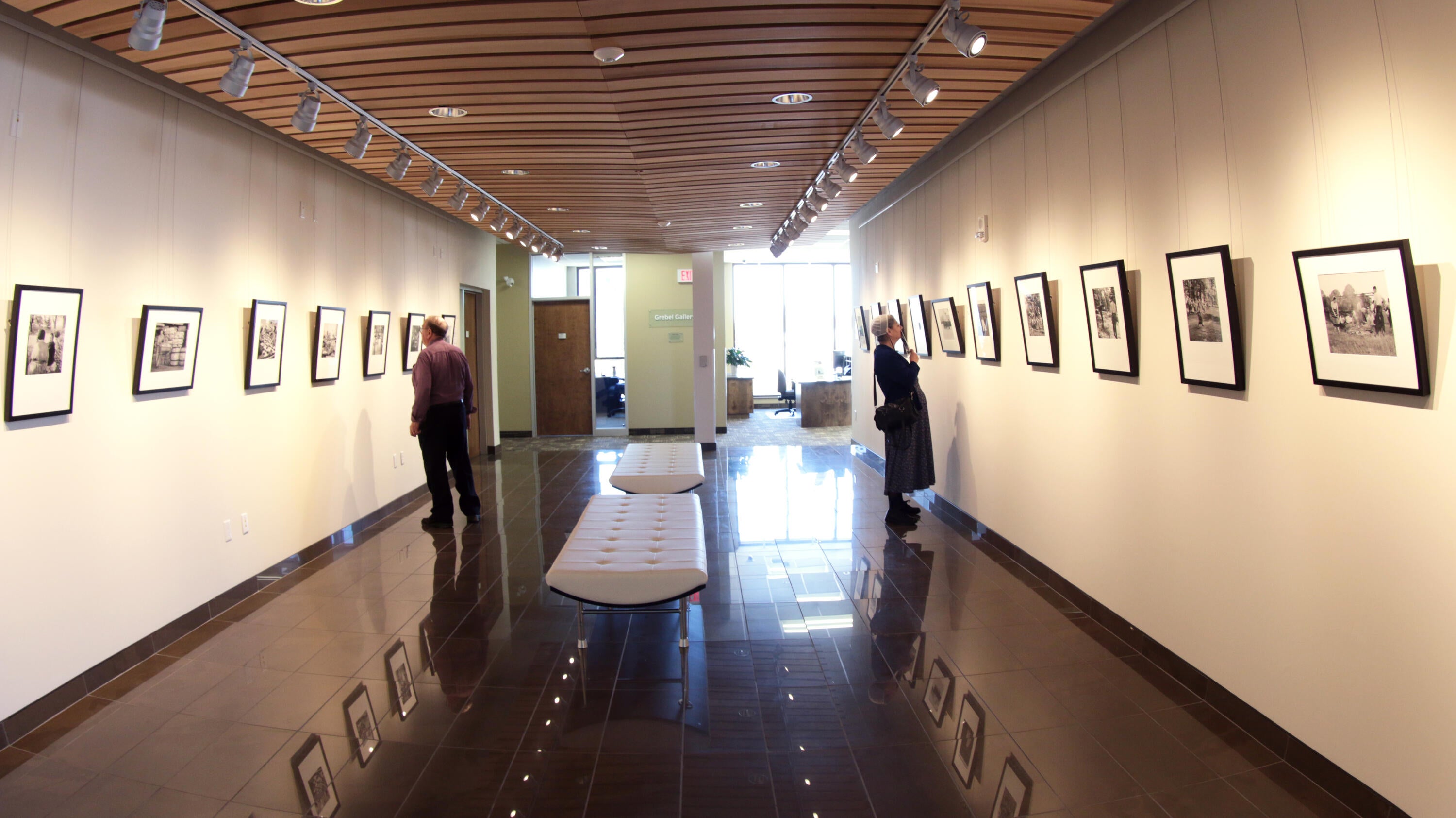 Small art gallery with cushioned benches in the middle