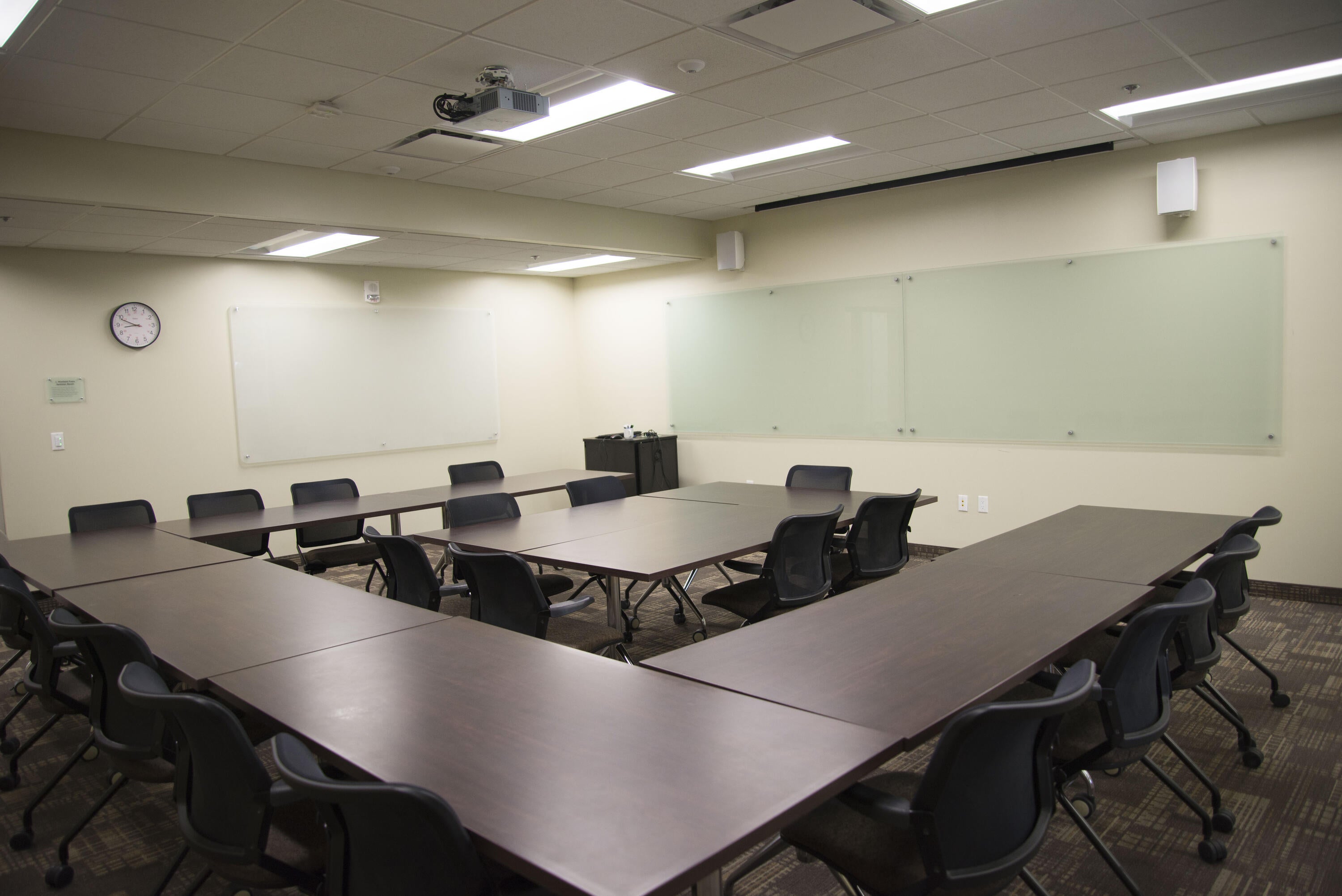 Classroom with long tables and chairs in a square