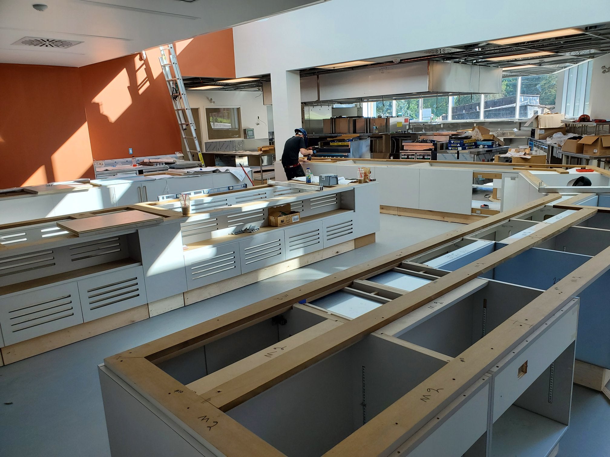 Cupboard structures begin being installed in the kitchen service area