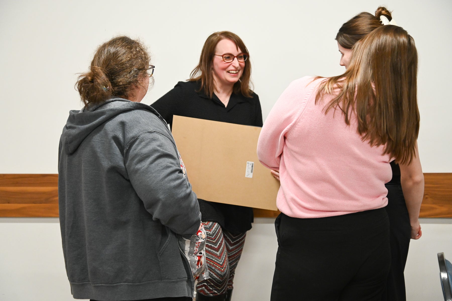 Kathryn Ladano talking to three students
