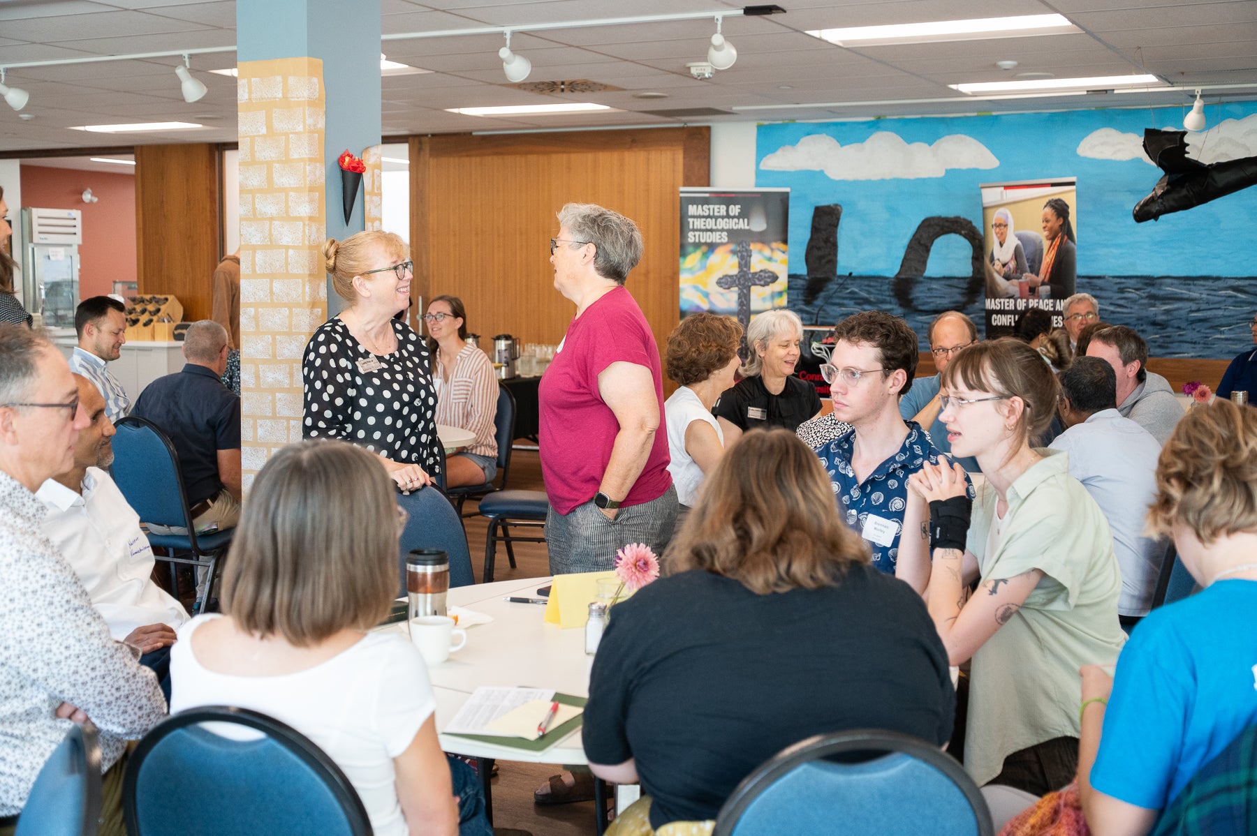 graduate students meet with faculty in the grebel dining room