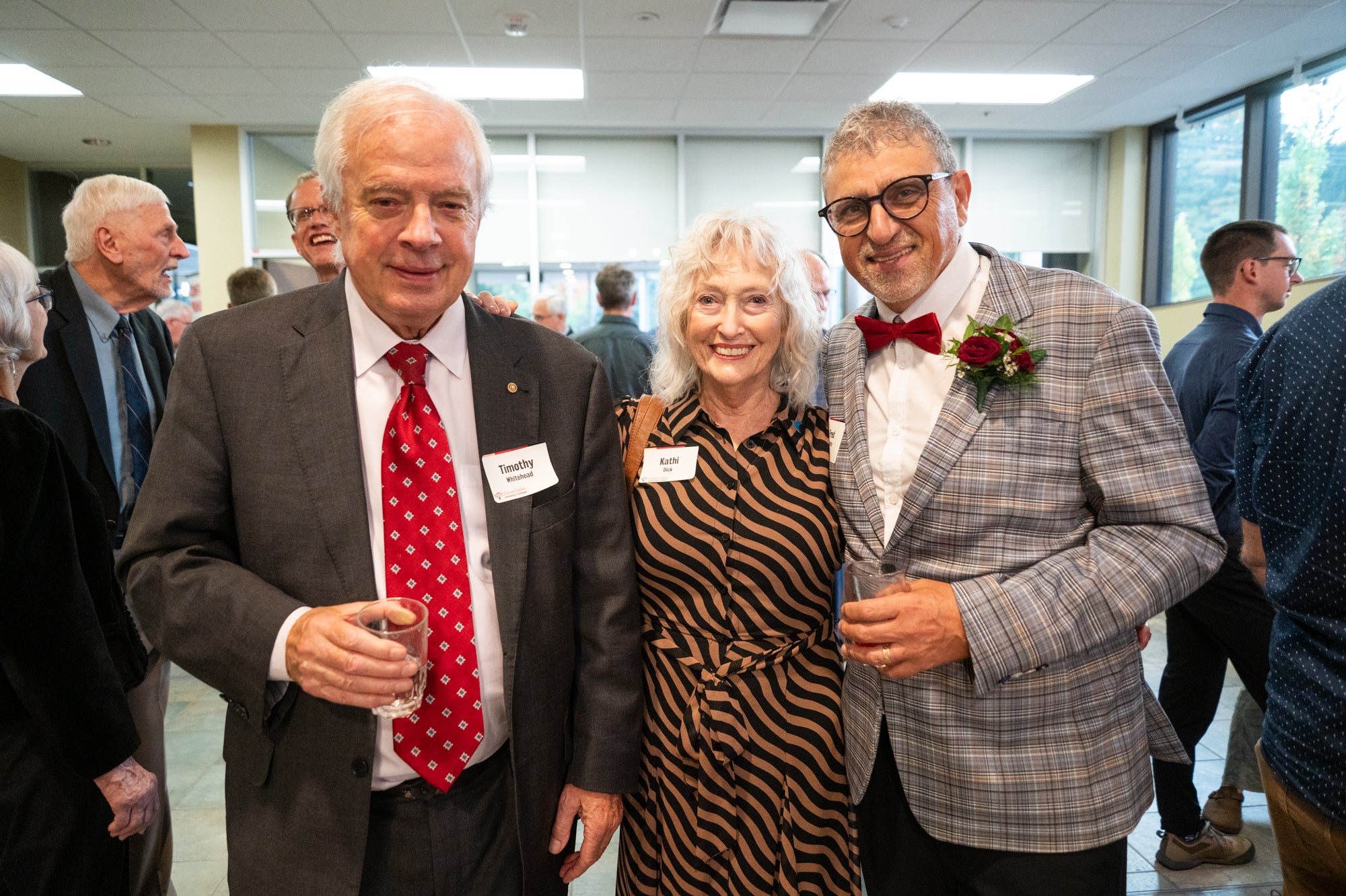 Fred stands with two Grebel donors for a picture