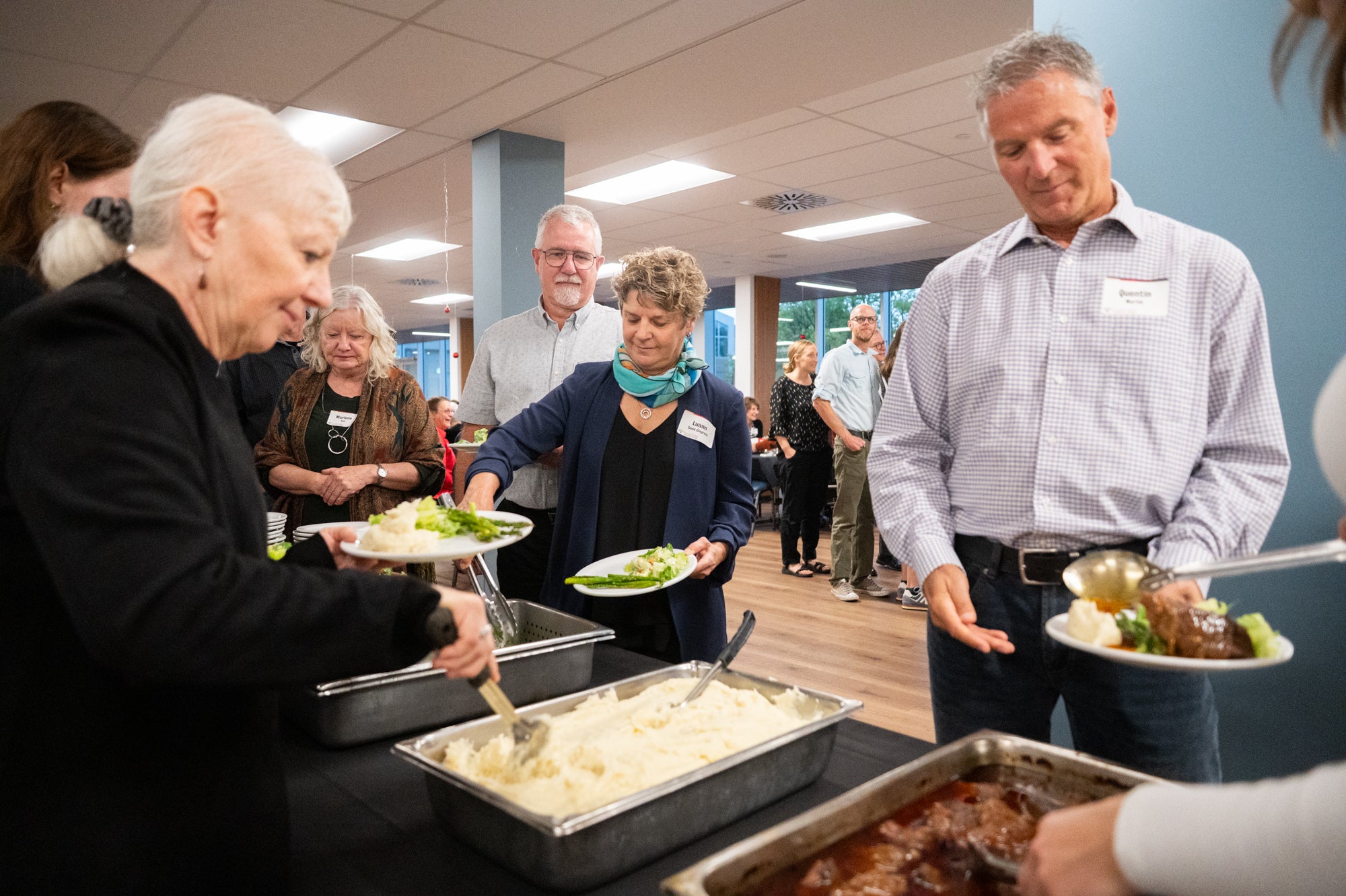 Guests enjoy food at Grebel during Fred's retirement