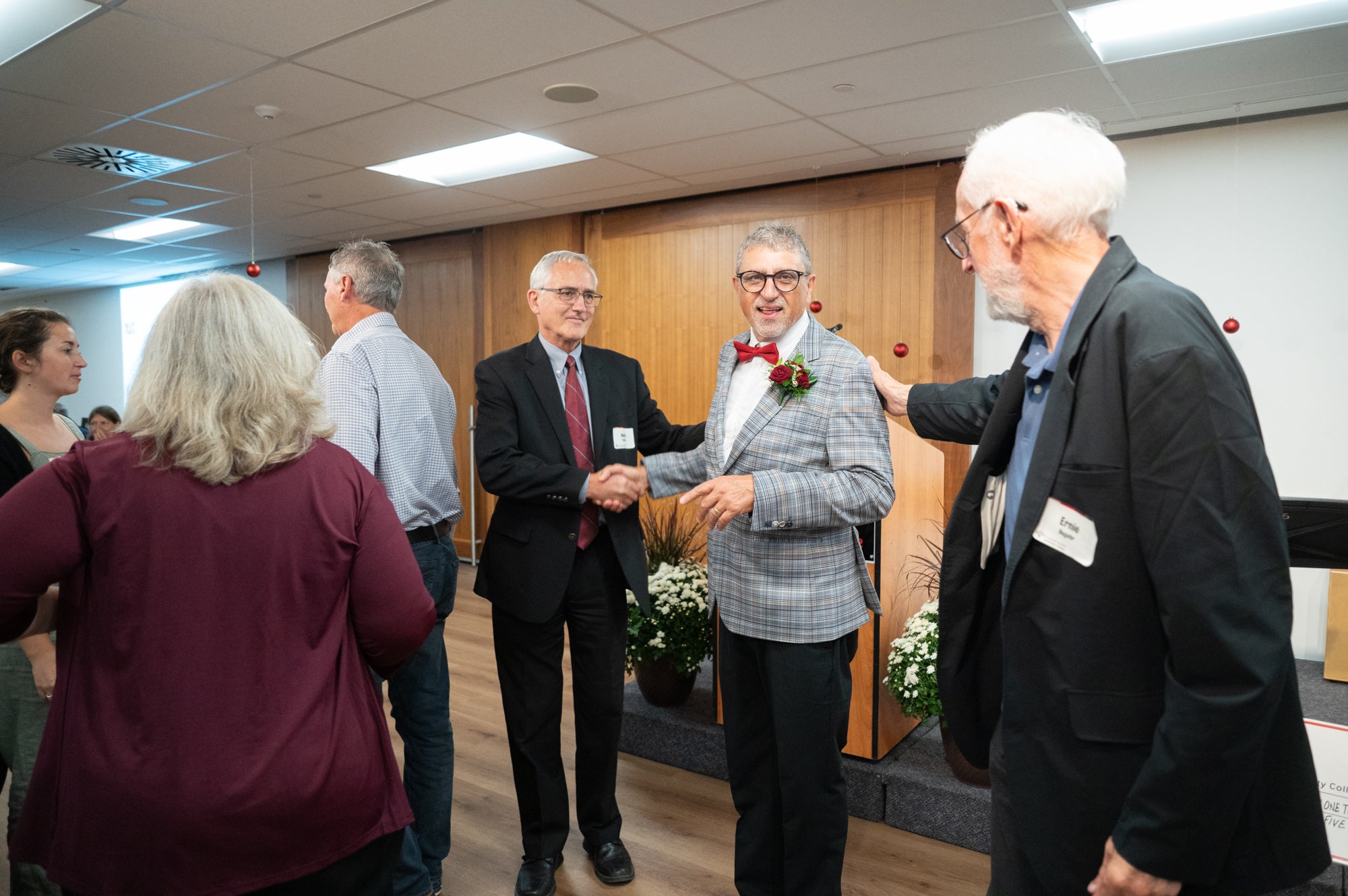 Fred shakes hands with guests