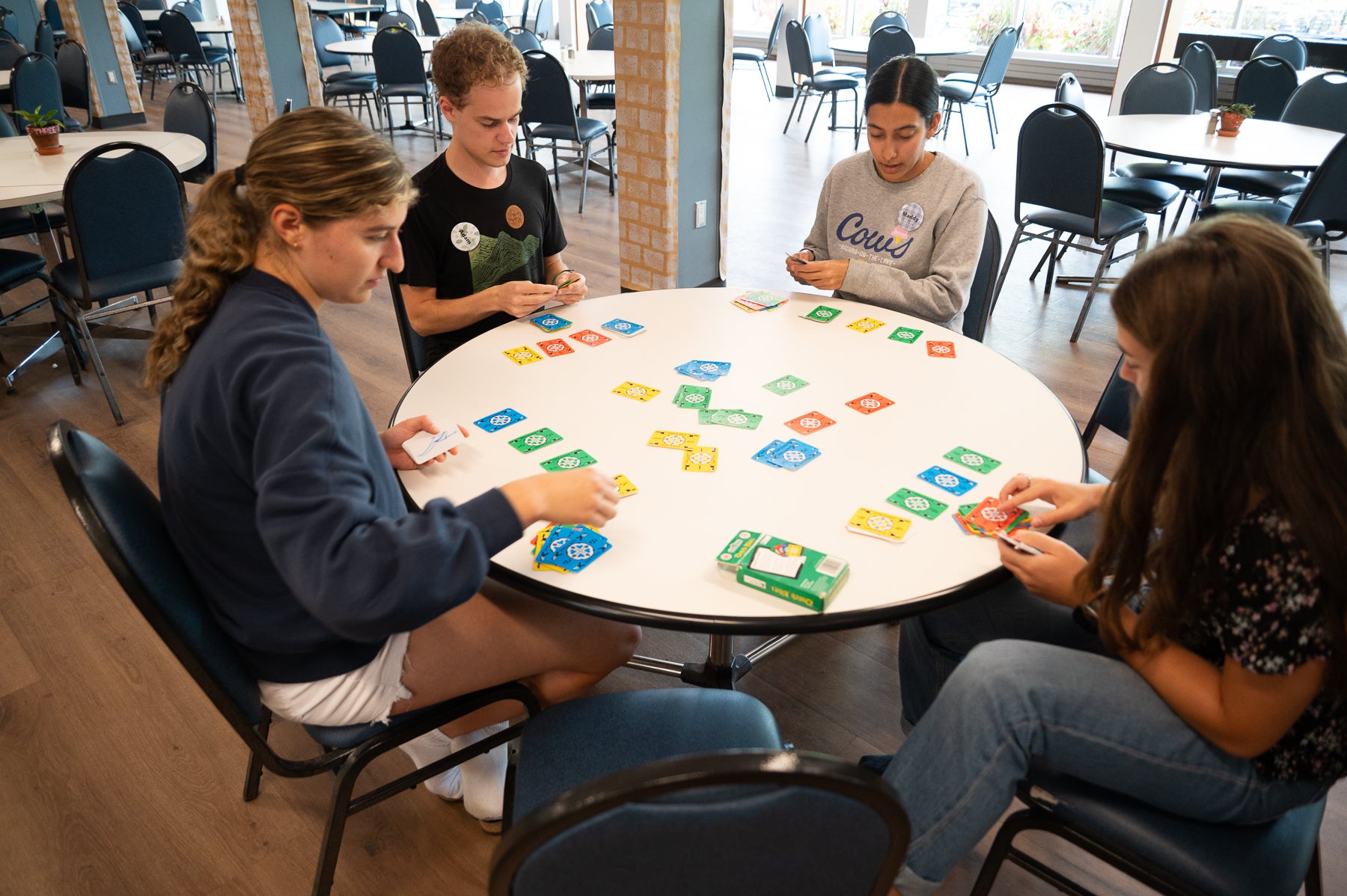 Students play dutch blitz in the grebel dining room