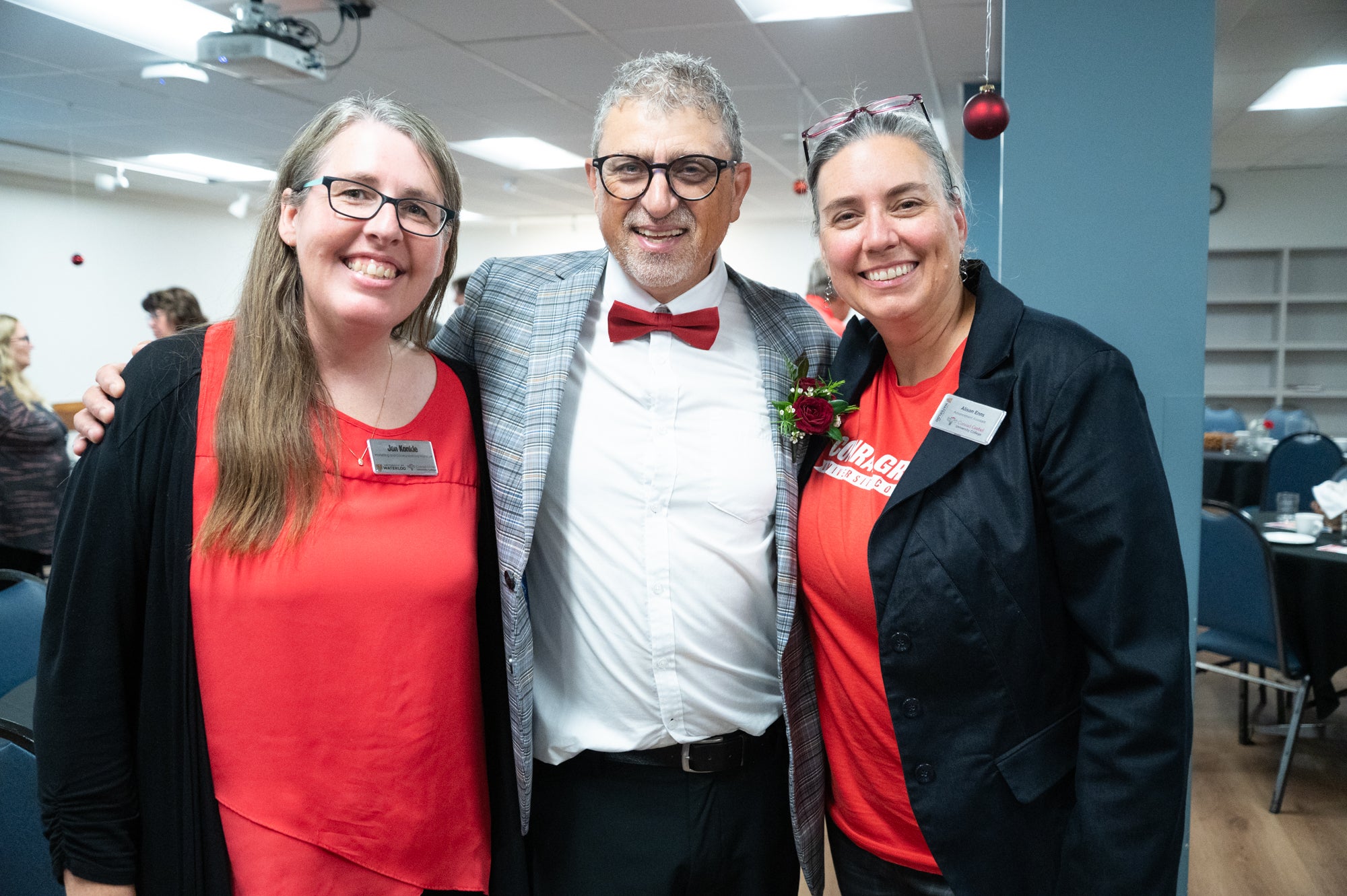 Fred stands between Jen and Alison for a photo