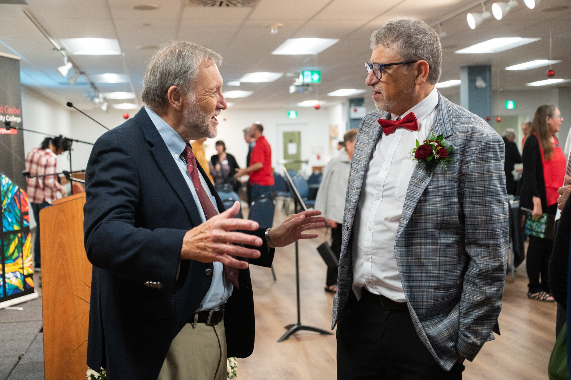 Fred speaks to a guest at his retirement