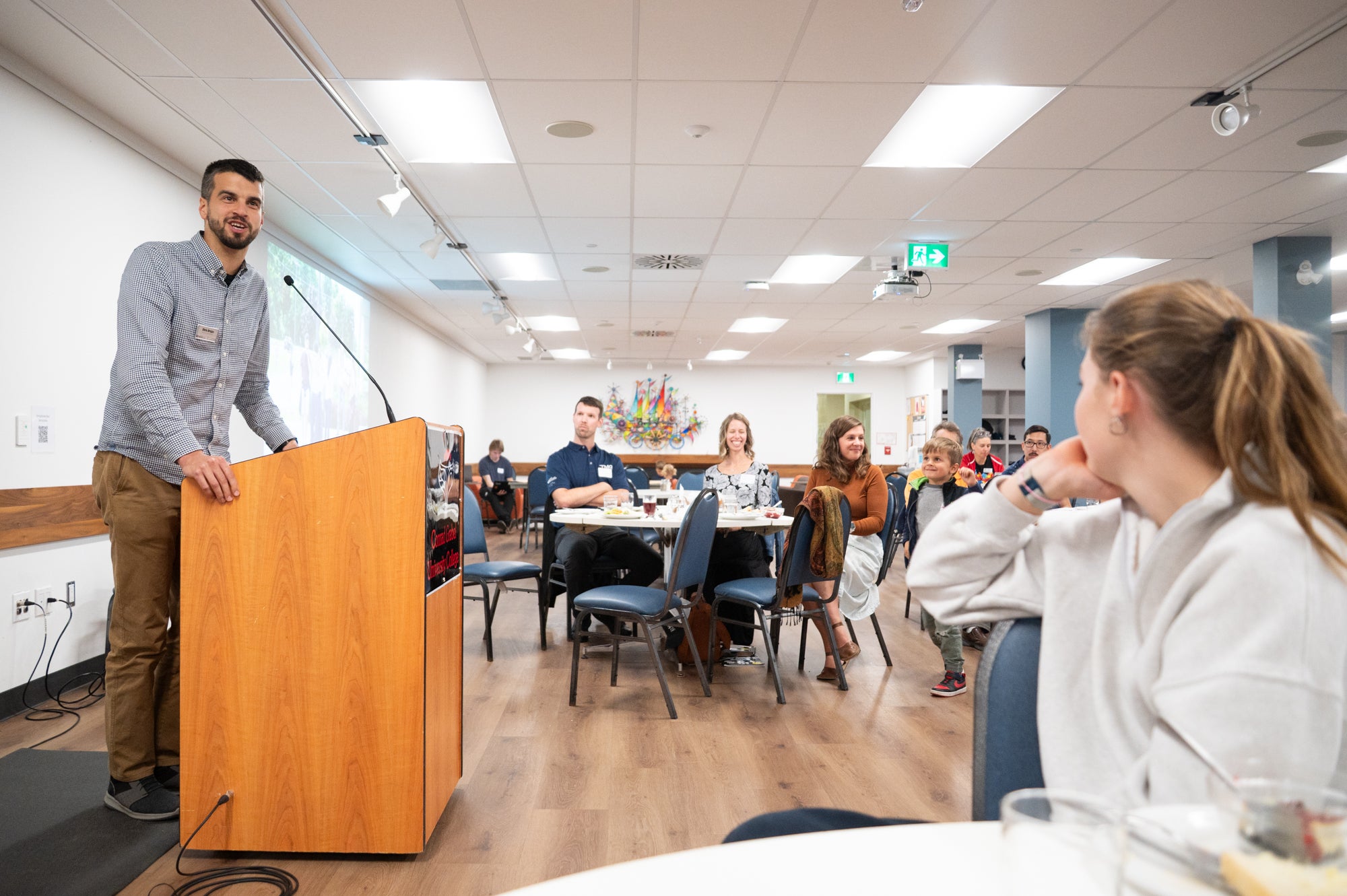 Chris Brnjas speaks to gathered attendees at the podium