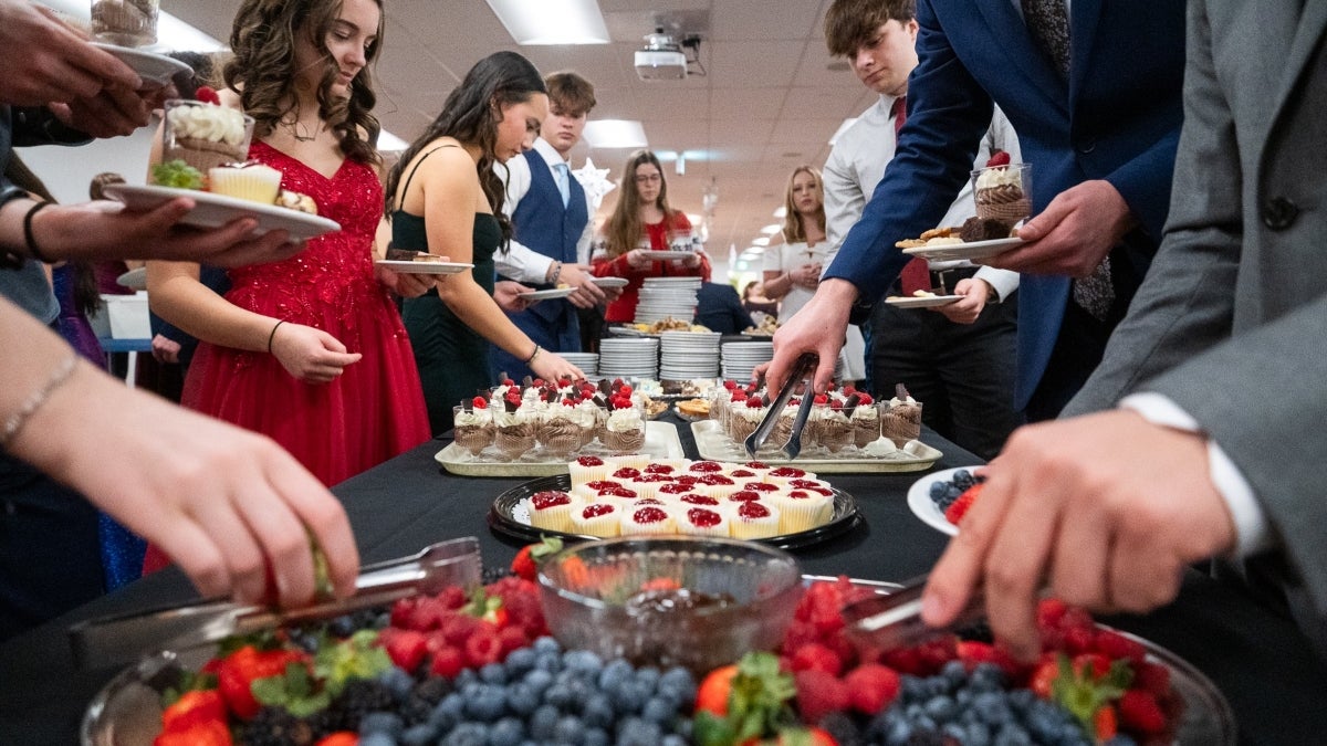 students choose from several small deserts at a banquet event