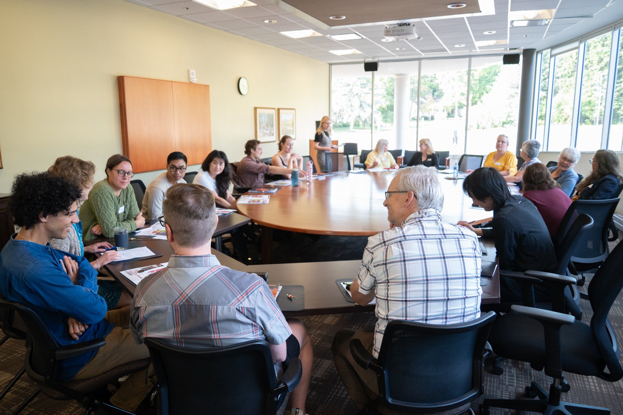 Students and faculty around a large meeting table