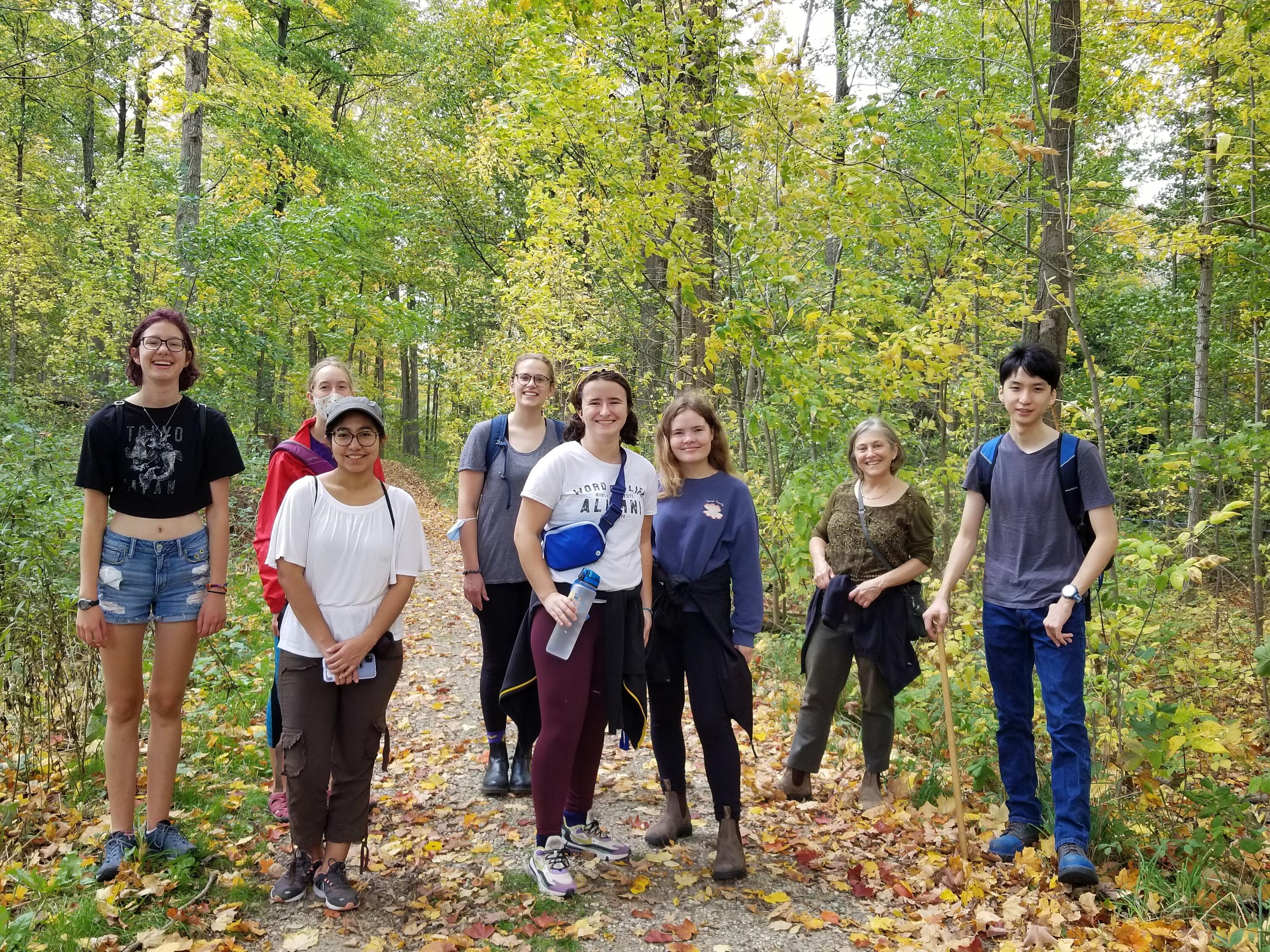 students standing in a group in a forest 