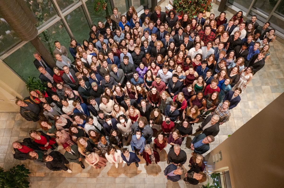 Group photo in the upper atrium, including students, staff, faculty.