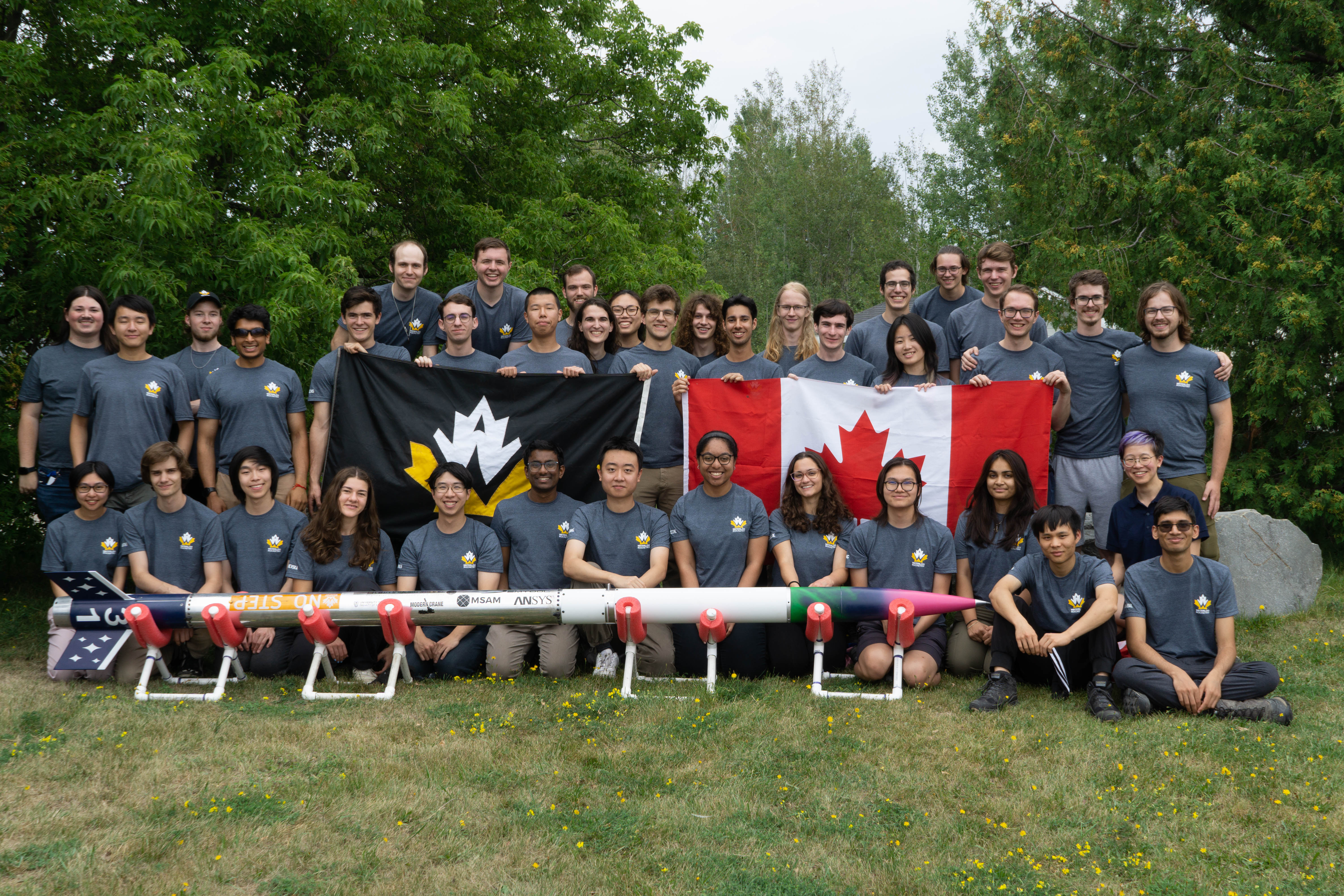 Team holding rocket group photo