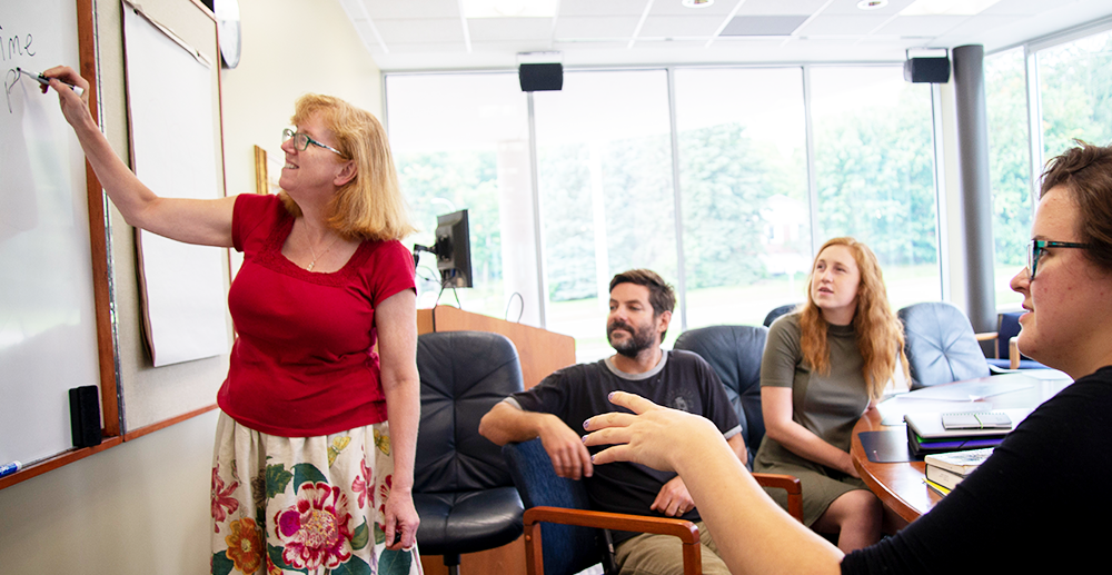 Carol Penner teaches at a whiteboard