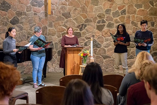 Students doing a reader's theatre in Chapel