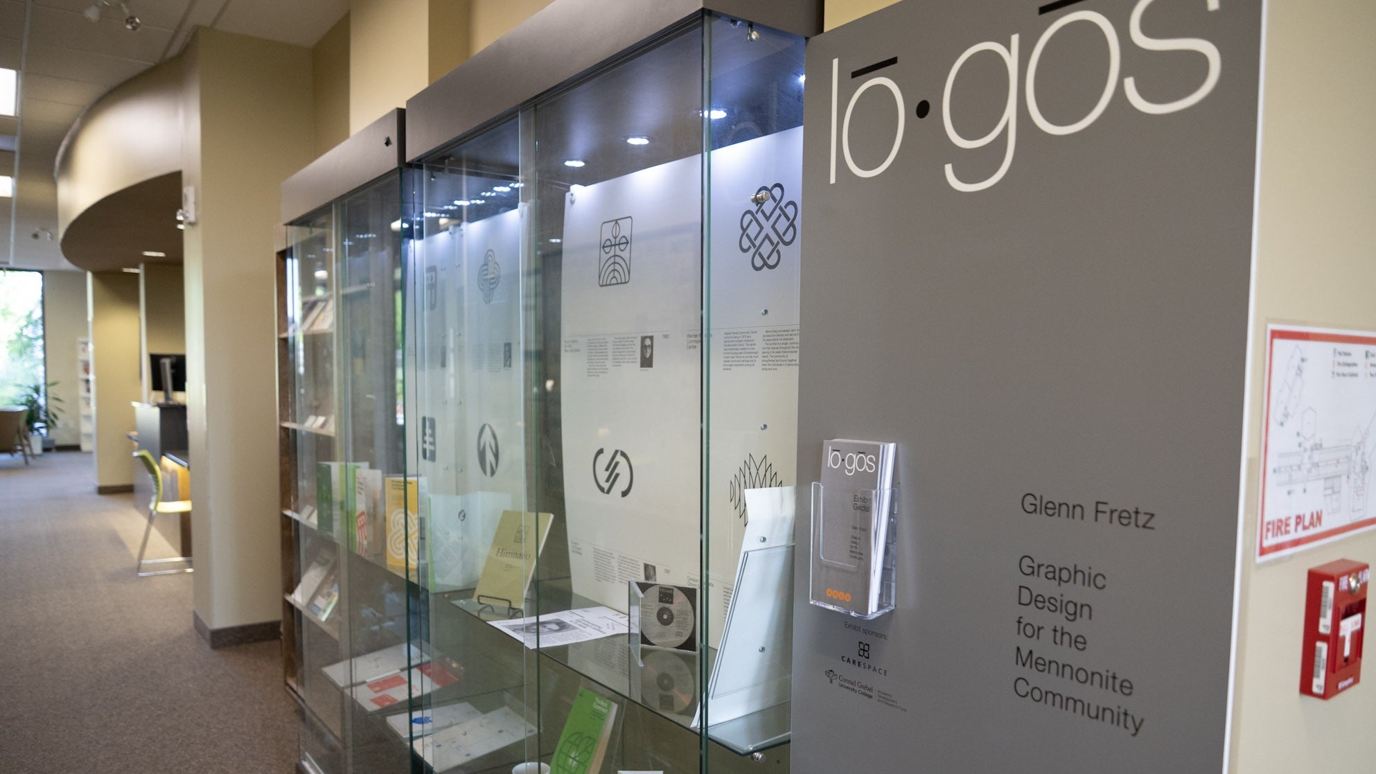 Exhibit display, full of materials designed by Glen Fretz in the library hallway
