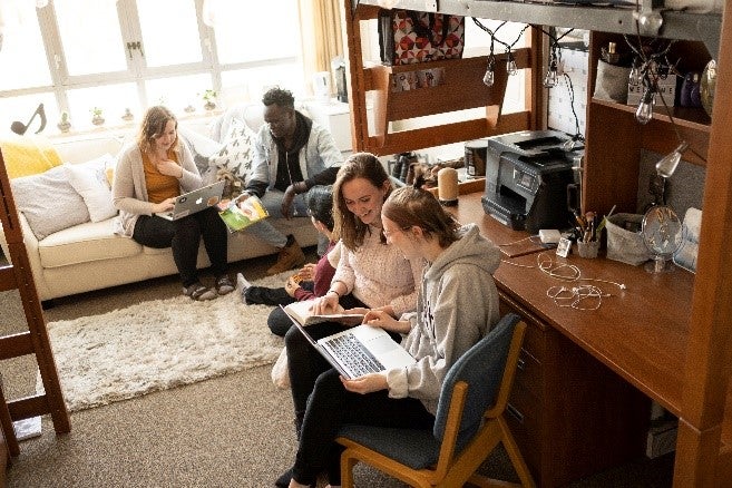 students collaborating in dorm room