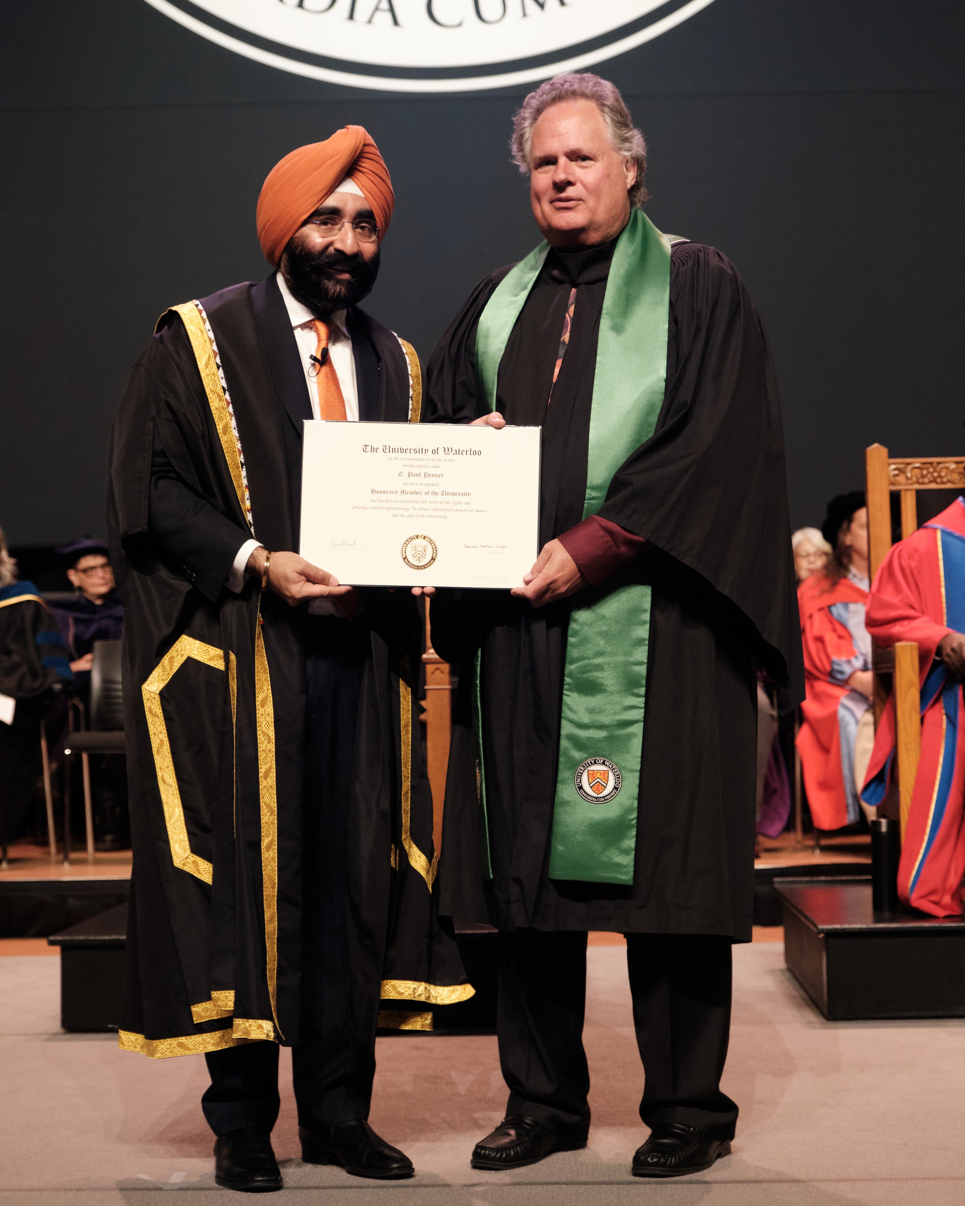 Paul being presented with his certificate on stage