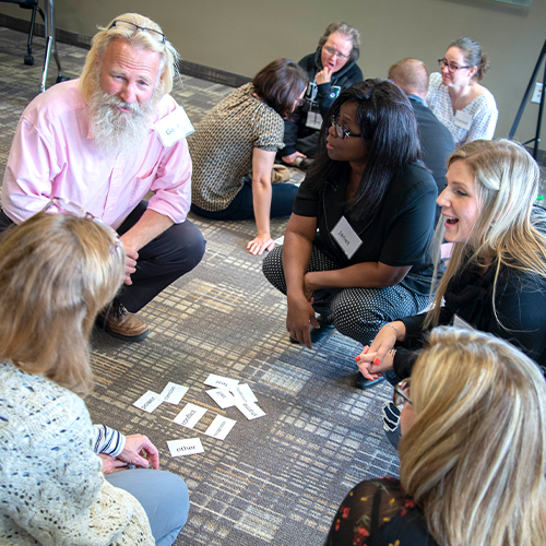 conflict management students gather around an excersize on the floor