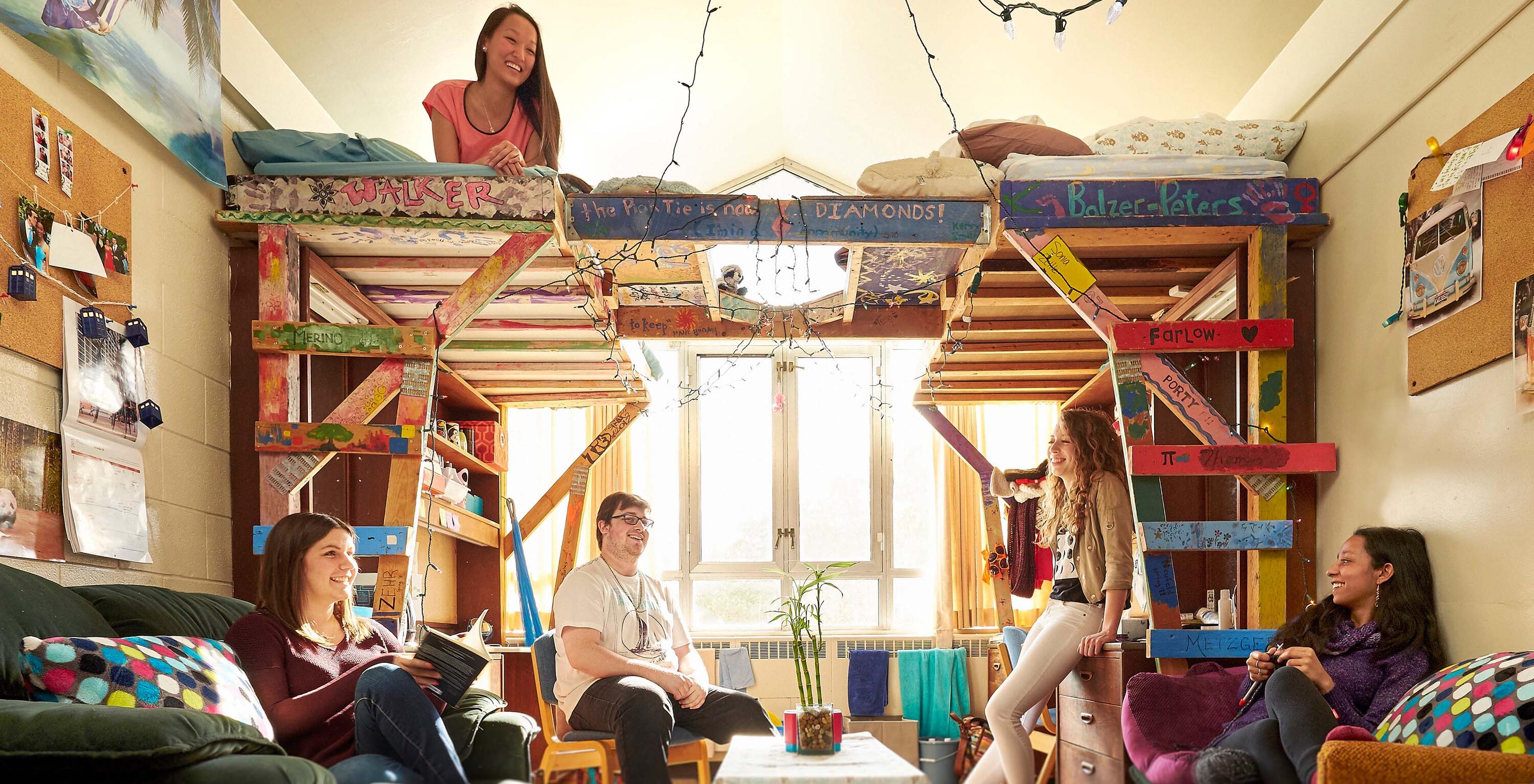 students relax in a room with a decorated skybunk