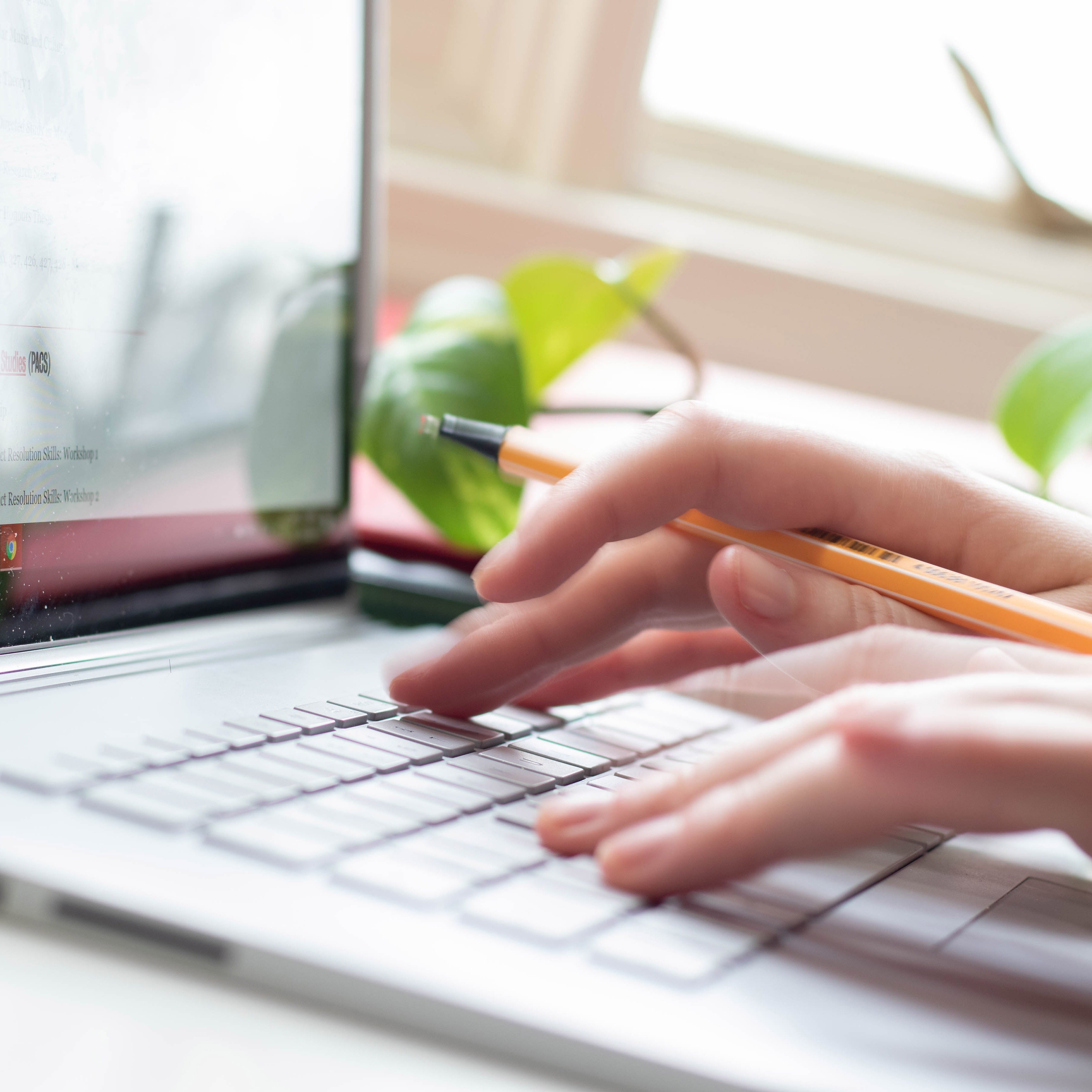 hand typing on a laptop