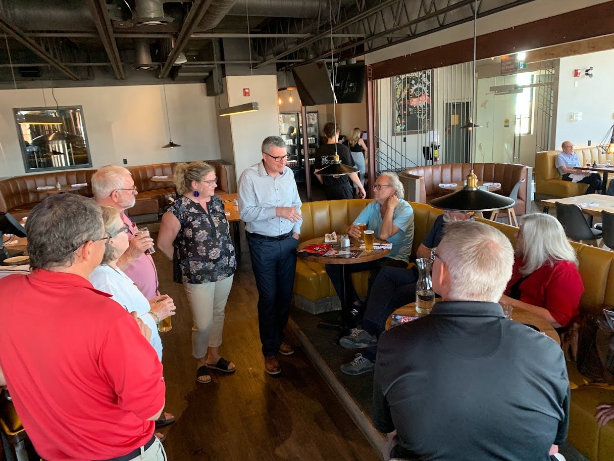 alumni standing together in a restaurant