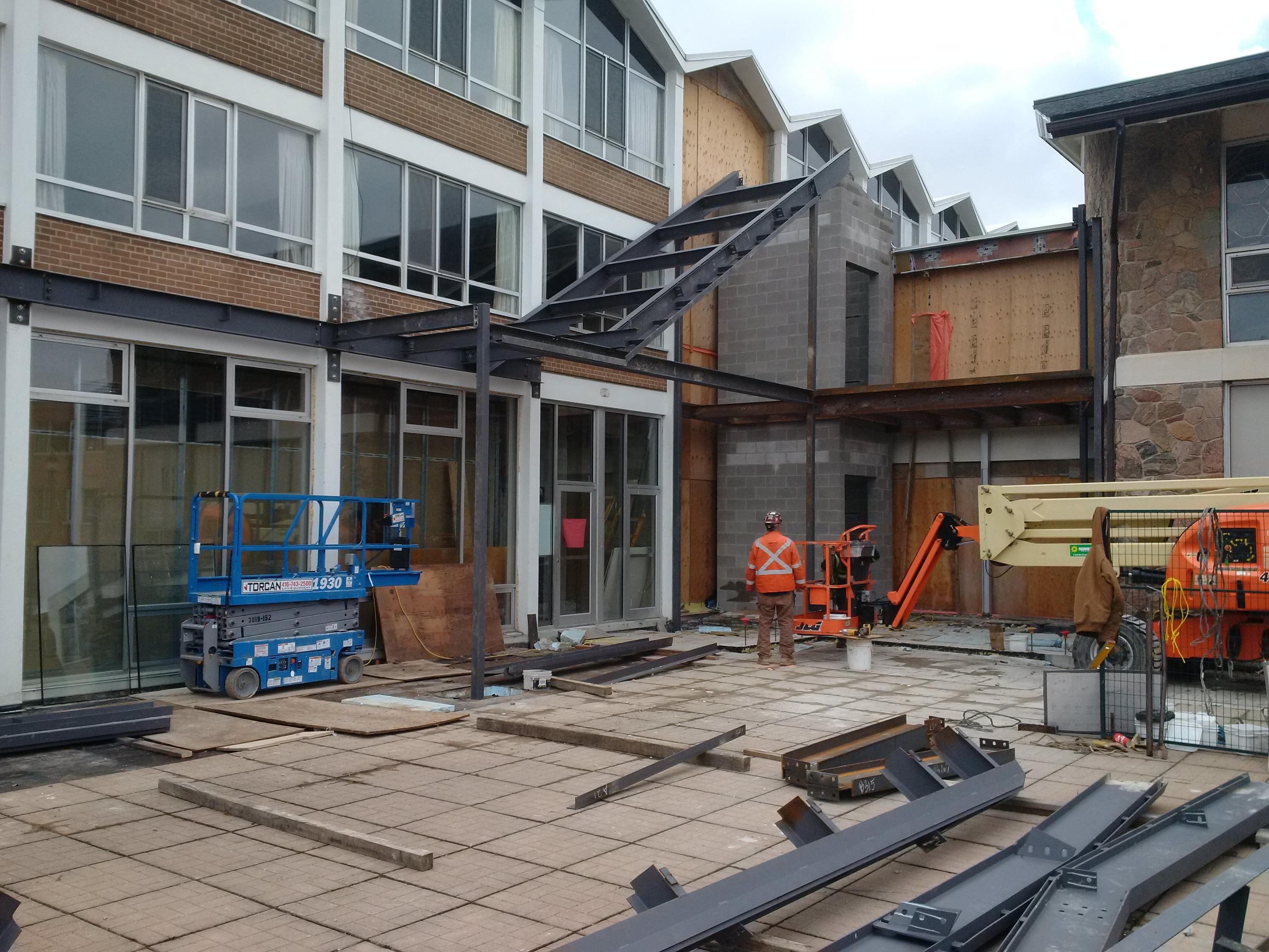 Steel beams are installed creating the structure for the new stairway on the patio