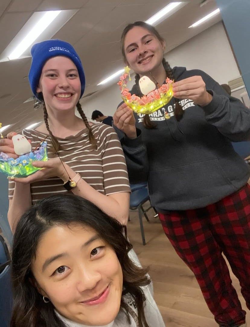 Jobina and two students holding up crafts