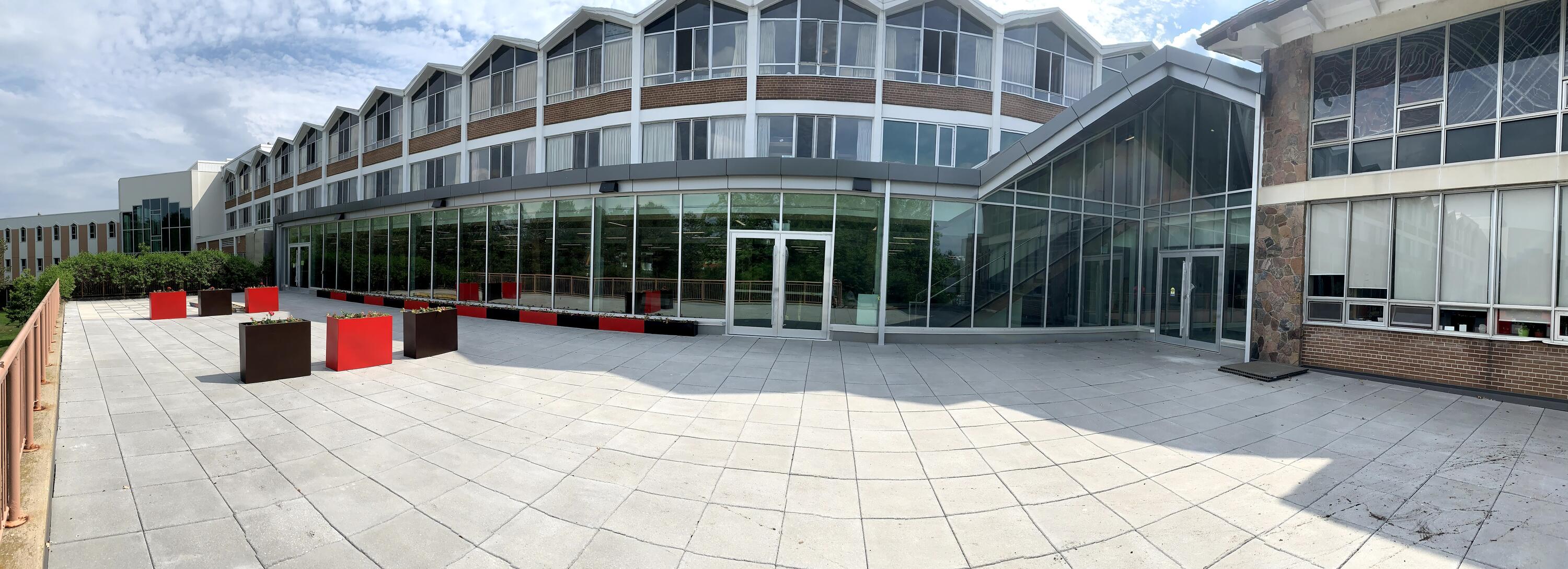 A panoramic view of the grebel patio and windows of the new dining room on a bright sunny day