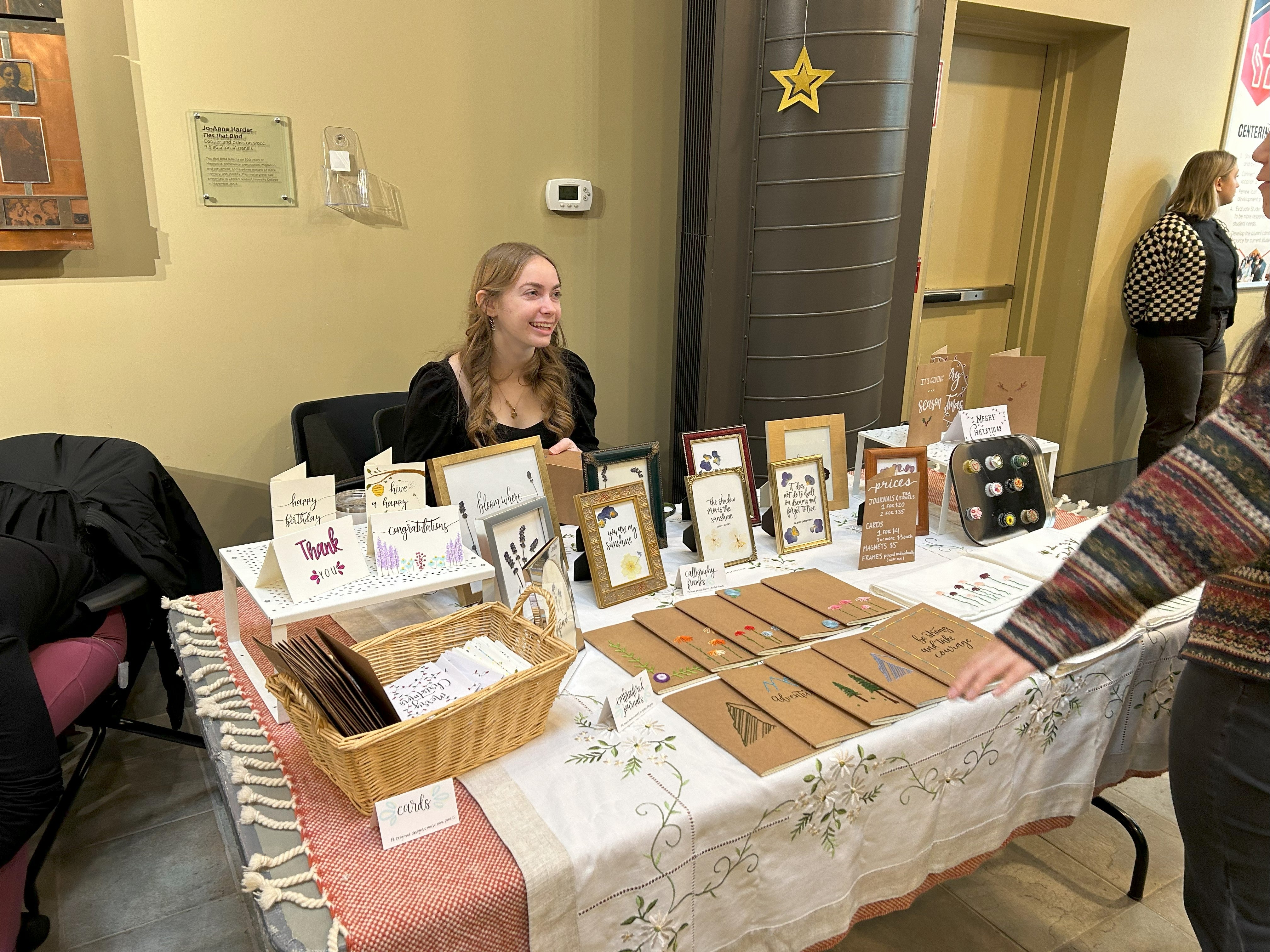 a vendor talking to a buyer at their table