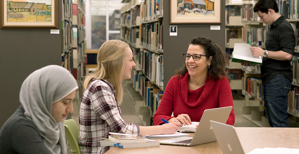 Jennifer ball with students in library