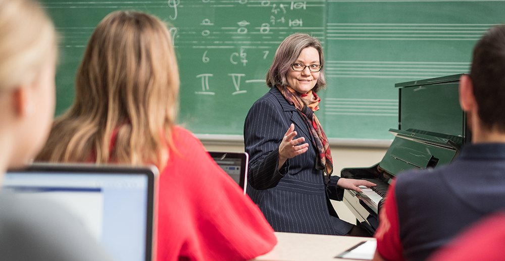 Karen Sunabacka teaches a music class at a piano