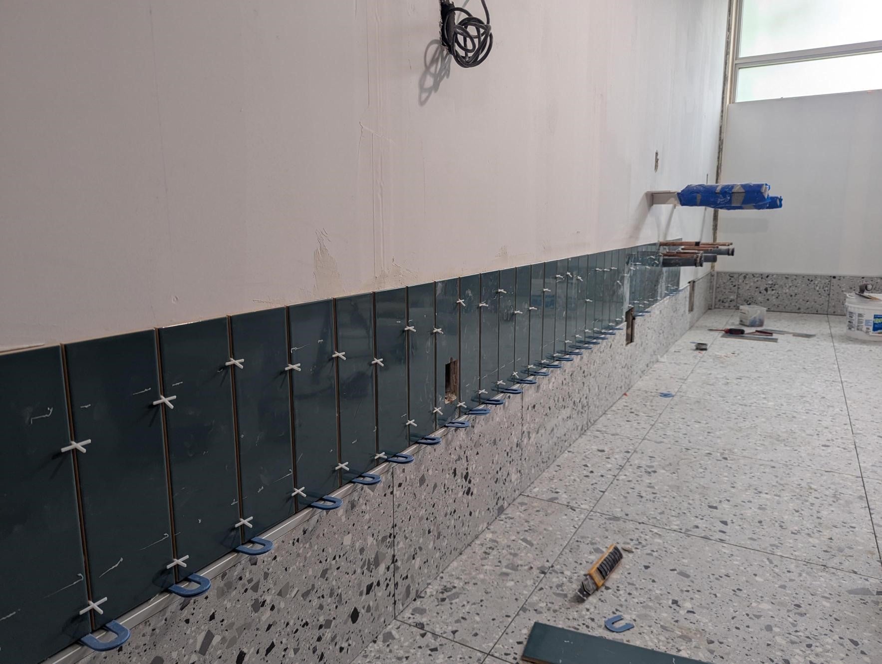 Tile on the bathroom walls being laid