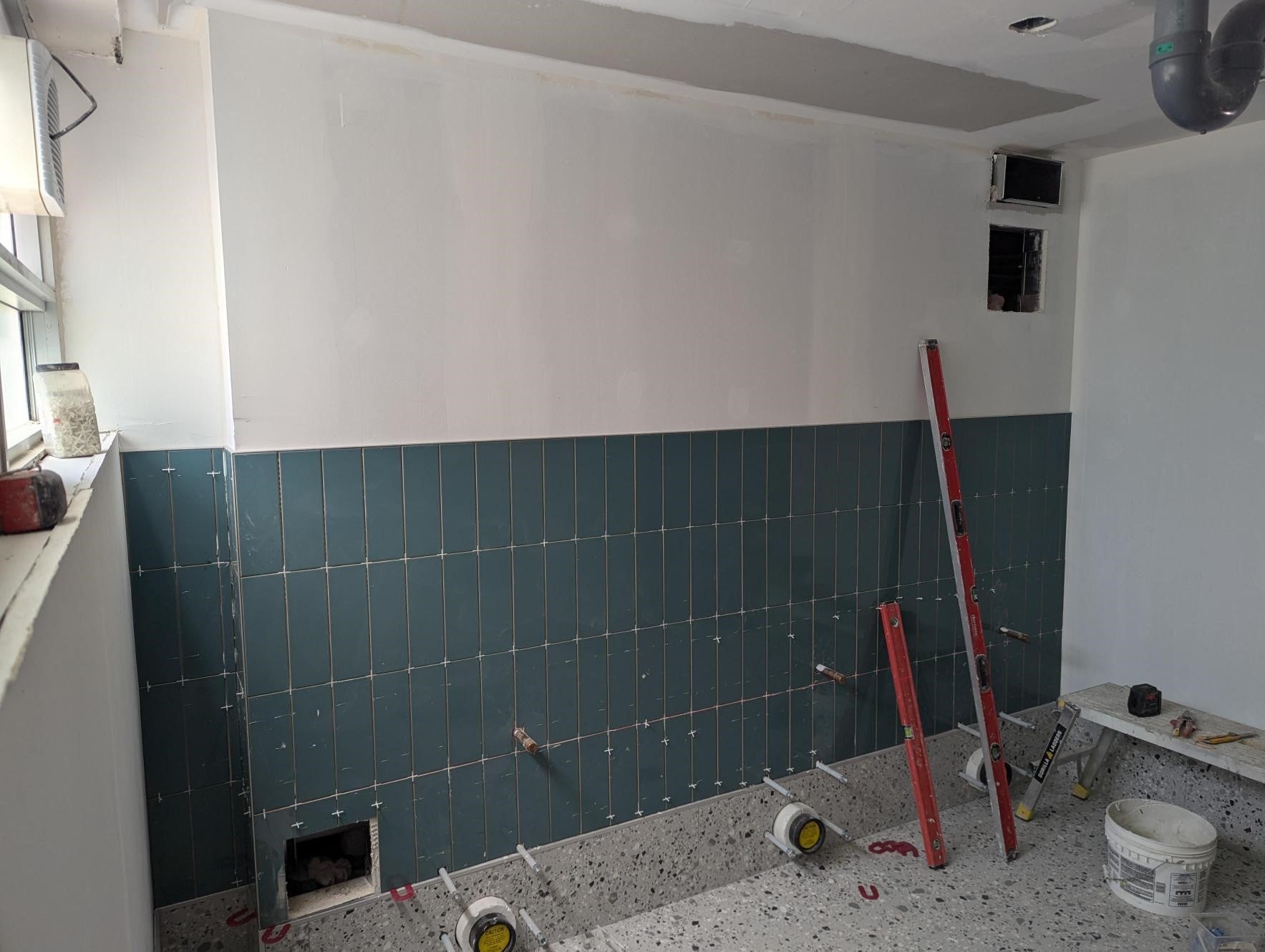 Tile on bathroom wall completed