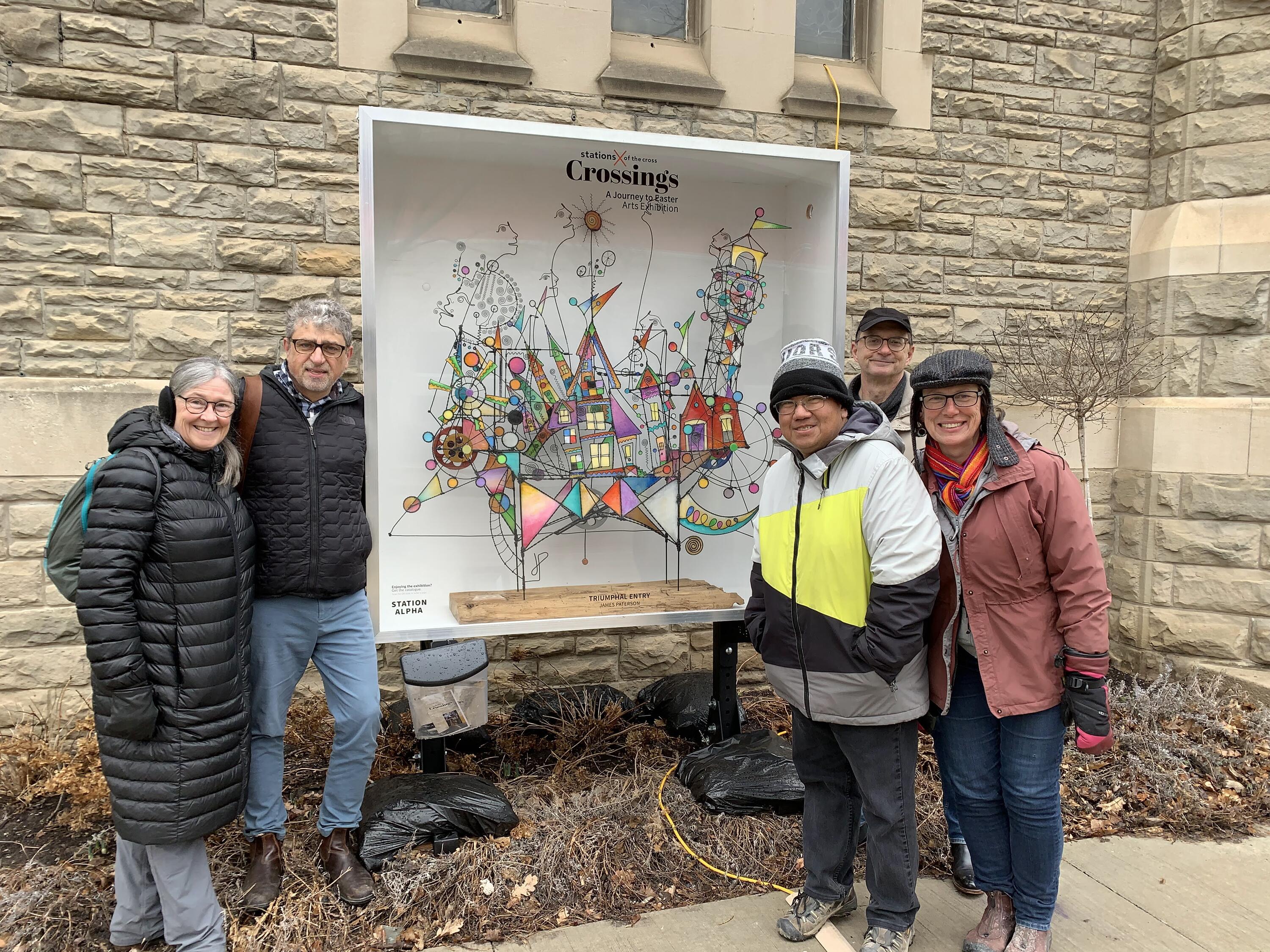 four grebel staff standing outside with Crossing's artwork 