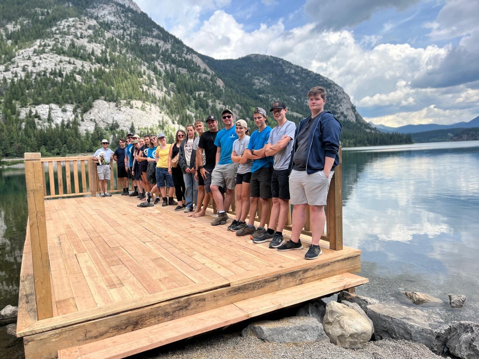 Group of MDS volunteers standing on a scenic dock in Alberta