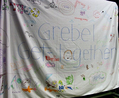 A piece of cloth that says “Grebel Get-together” and is decorated with drawings