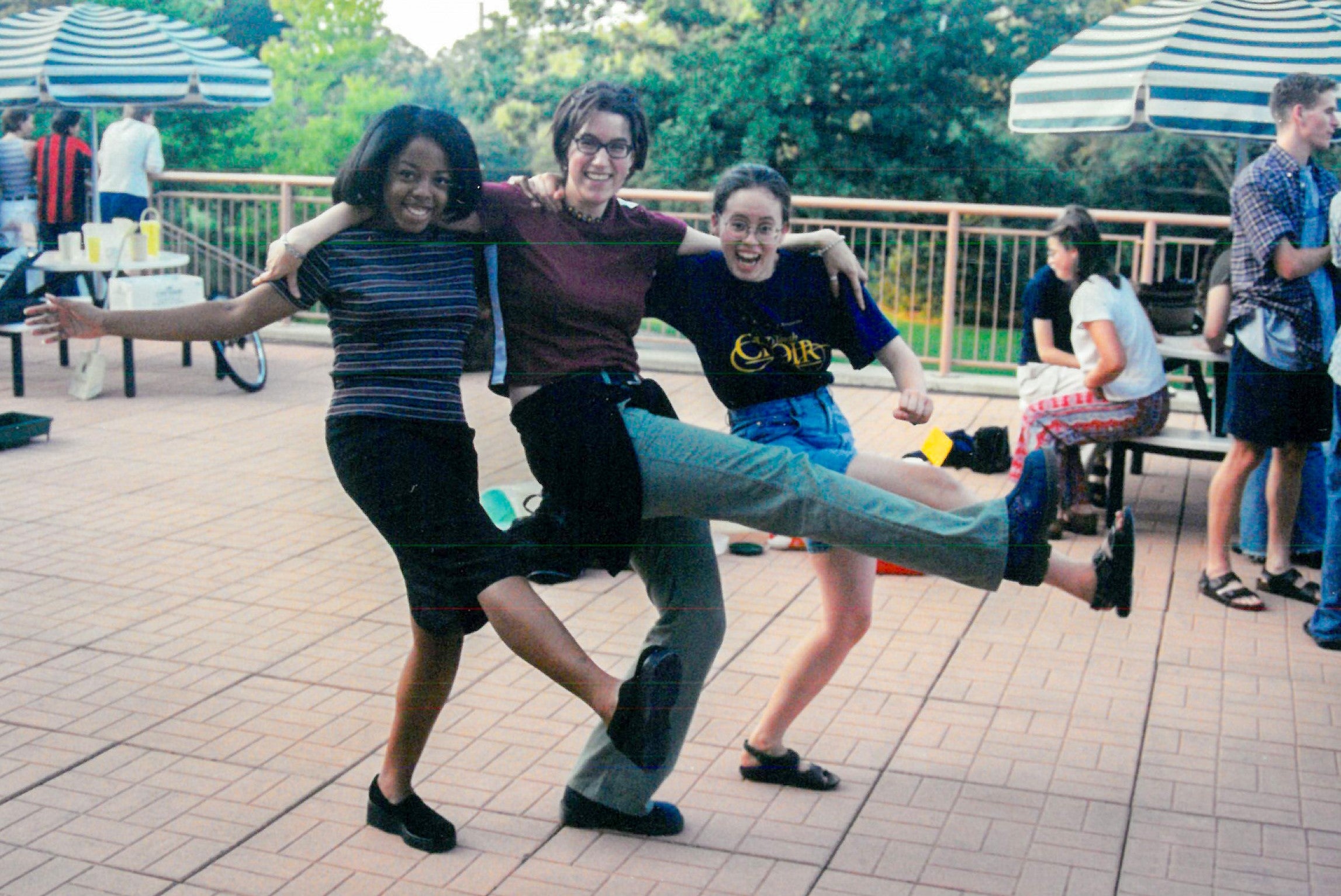 Three students dancing outside