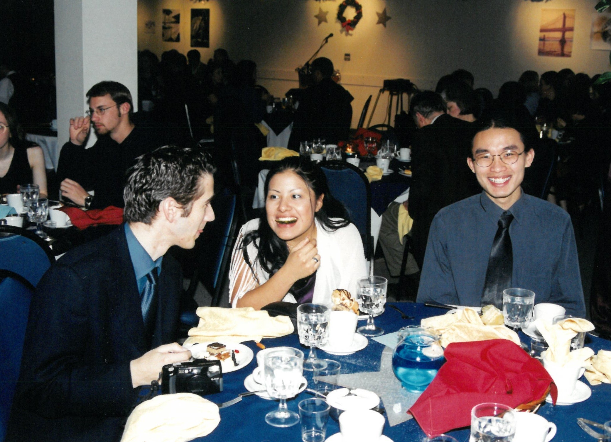Three students eating dinner at a banquet