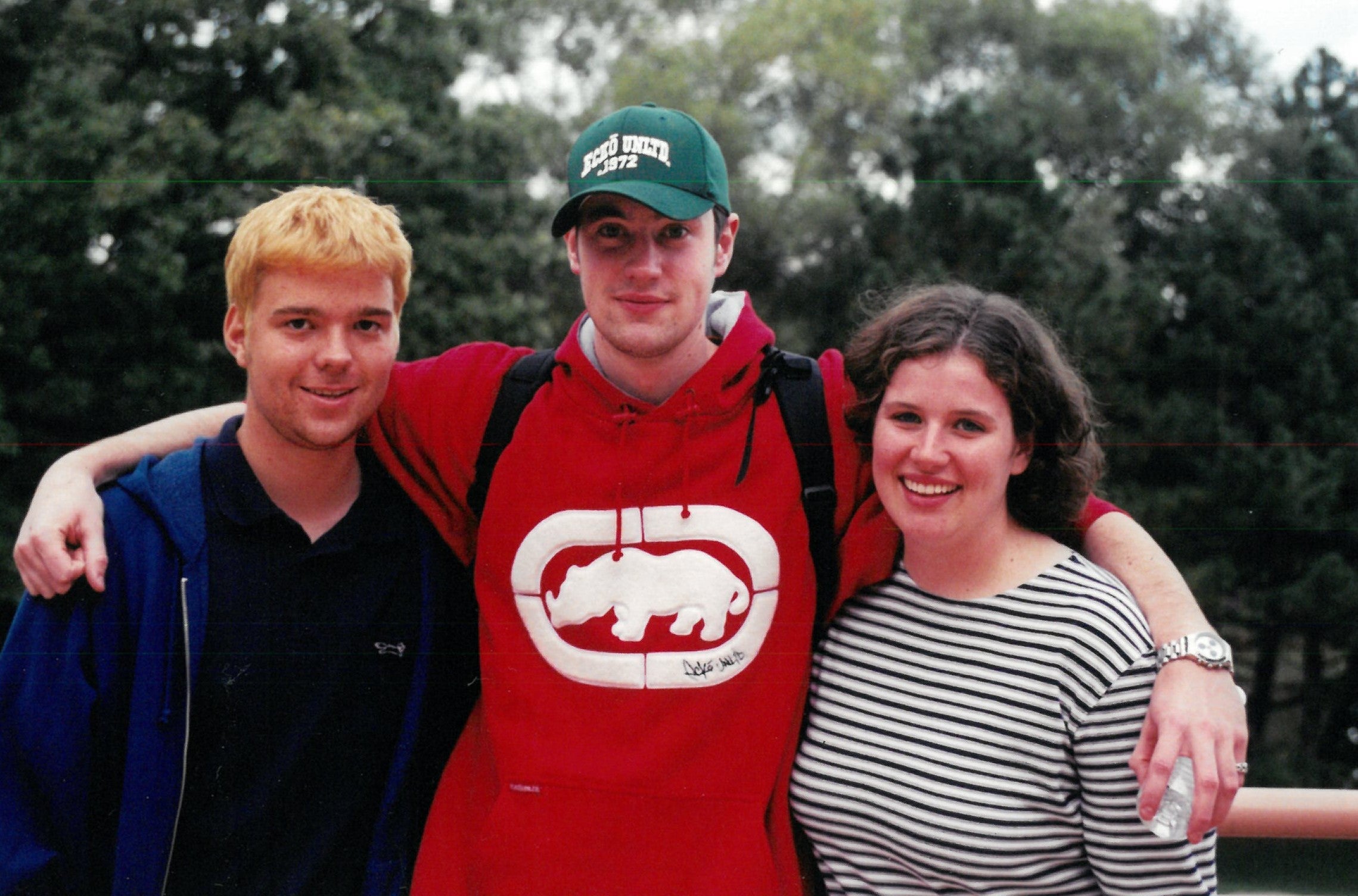 Three students smiling together