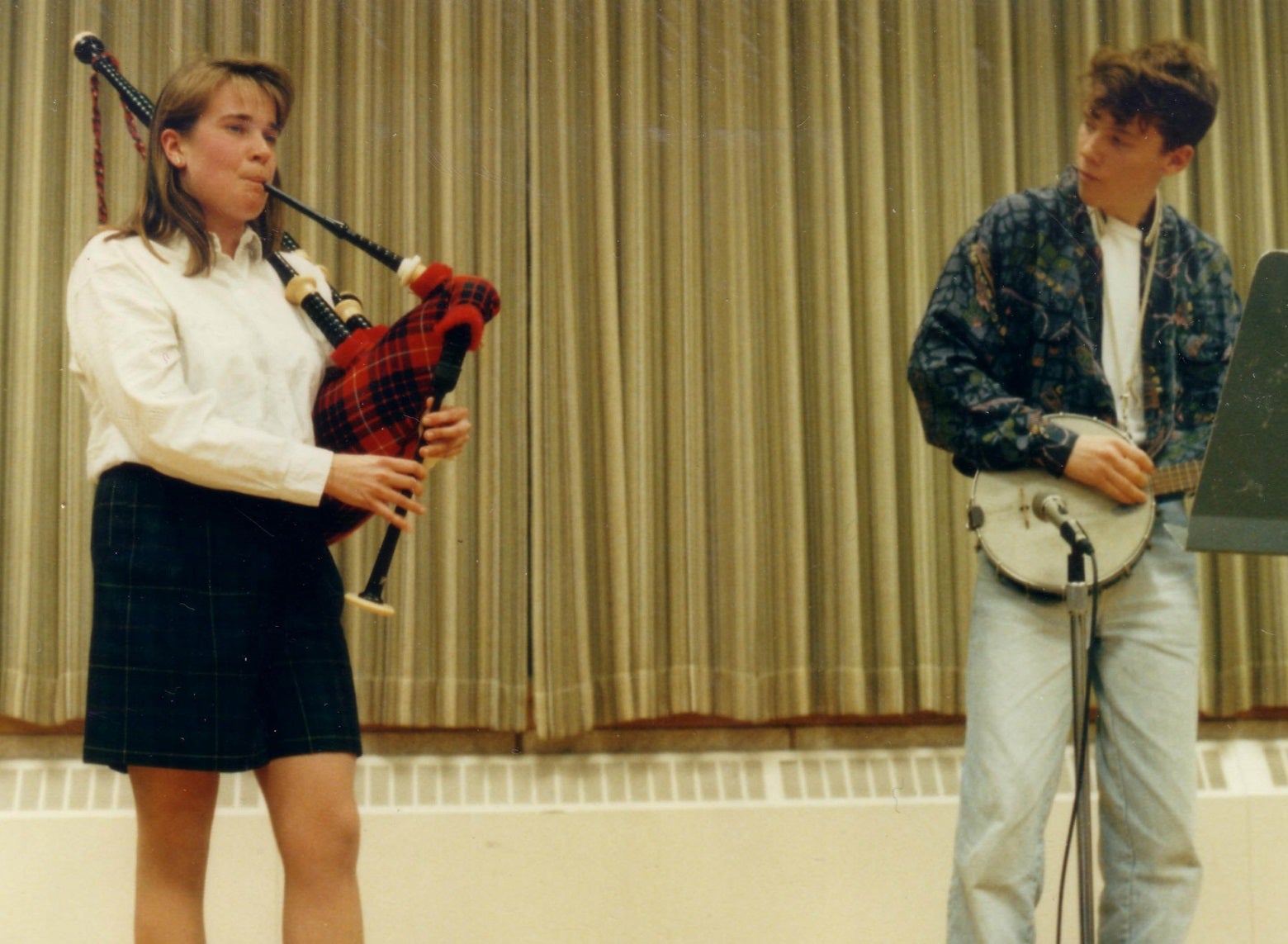 Two students, one plays bagpipes and the other a banjo on the Grebel stage (90s)
