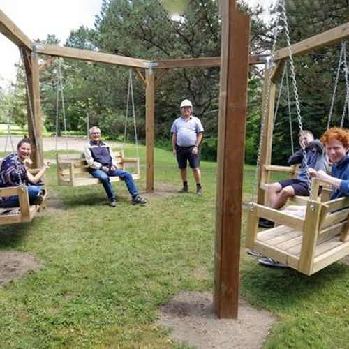 students on swings outside grebel