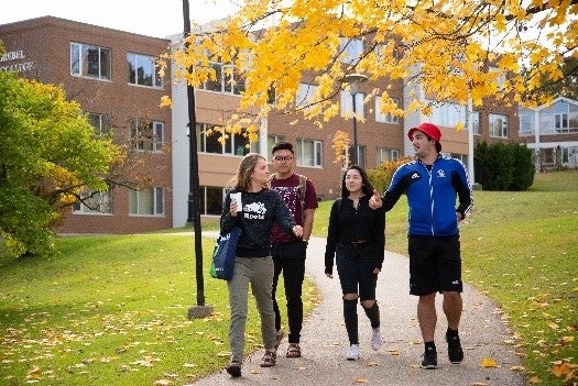 Conrad Grebel University College students walking down path outside the school
