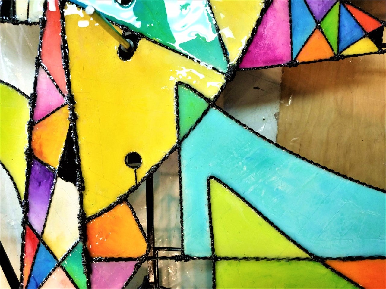 close up of the brightly coloured resin panels, various triangles