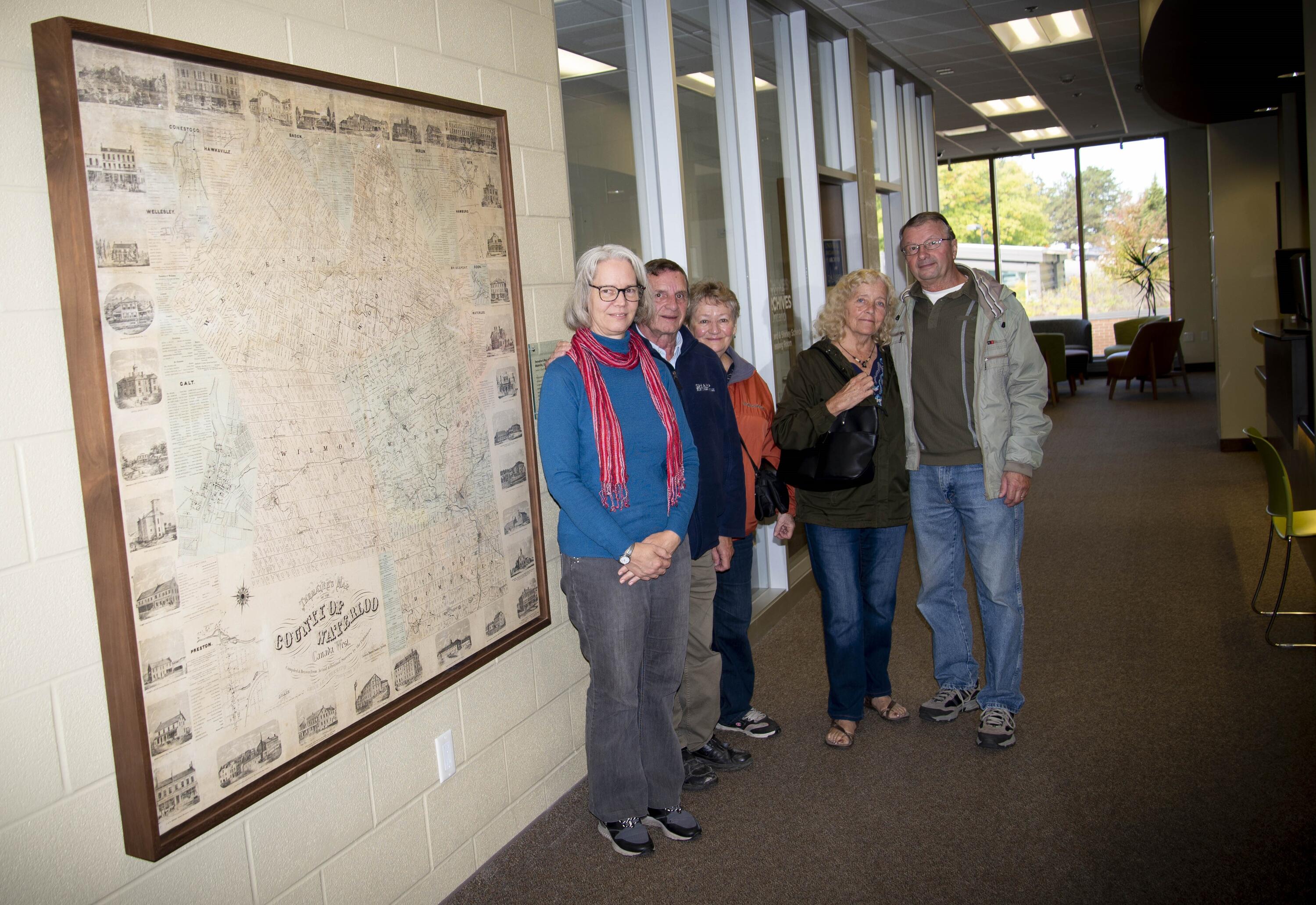 Staff standing beside Tremaine Map