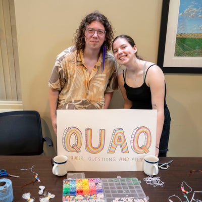 Max and Katiana posing by QuAQ sign during 2024 Open Doors Event